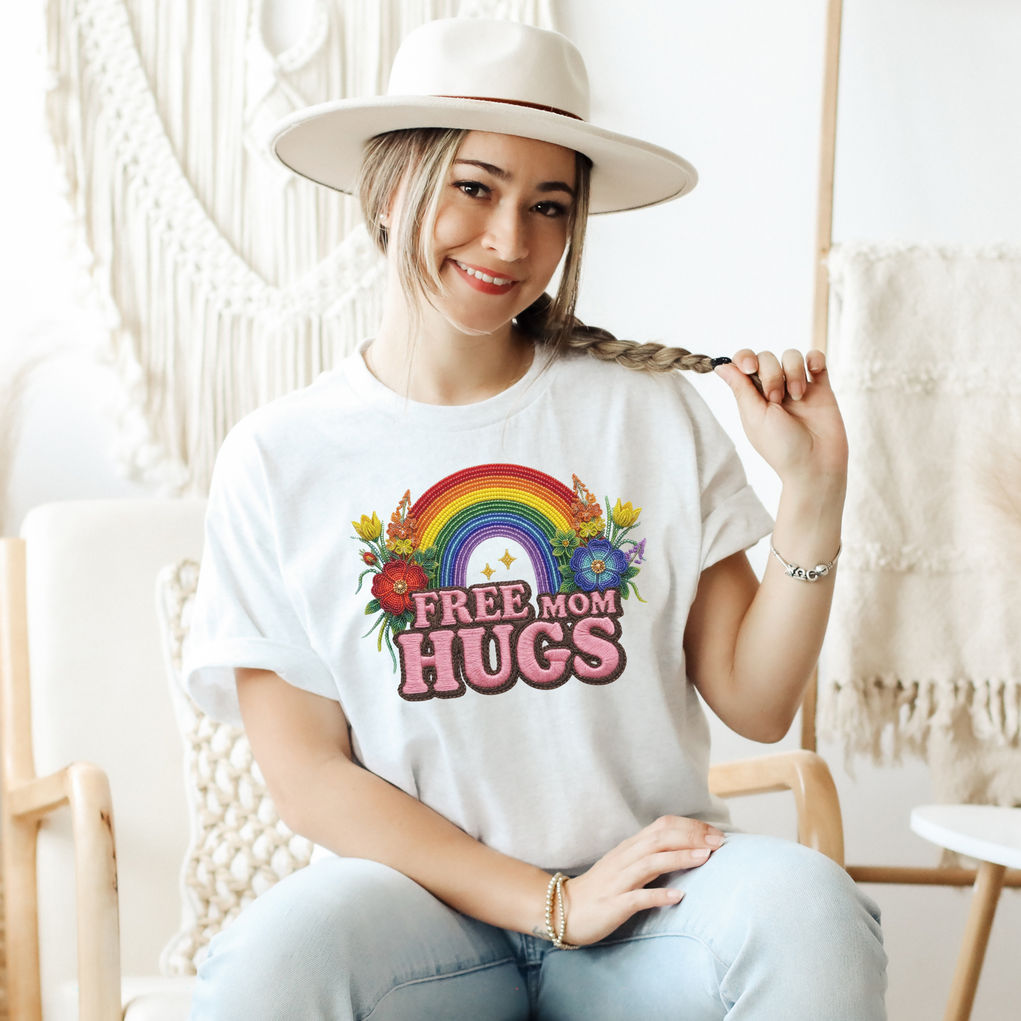 Free Mom Hugs Shirt featuring Indigenous-inspired beaded floral artwork, rainbow design, and pink faux embroidered lettering. free mom hugs shirt, pride shirt, indigenous floral shirt, beaded floral shirt, rainbow pride shirt, lgbtq ally shirt, supportive mom shirt, pride parade shirt, indigenous inspired apparel, faux embroidery shirt, mom hugs shirt, rainbow floral tee, inclusive apparel, pride month shirt, indigenous beadwork design, ally gift, lgbtq support shirt, community love shirt, acceptance shirt