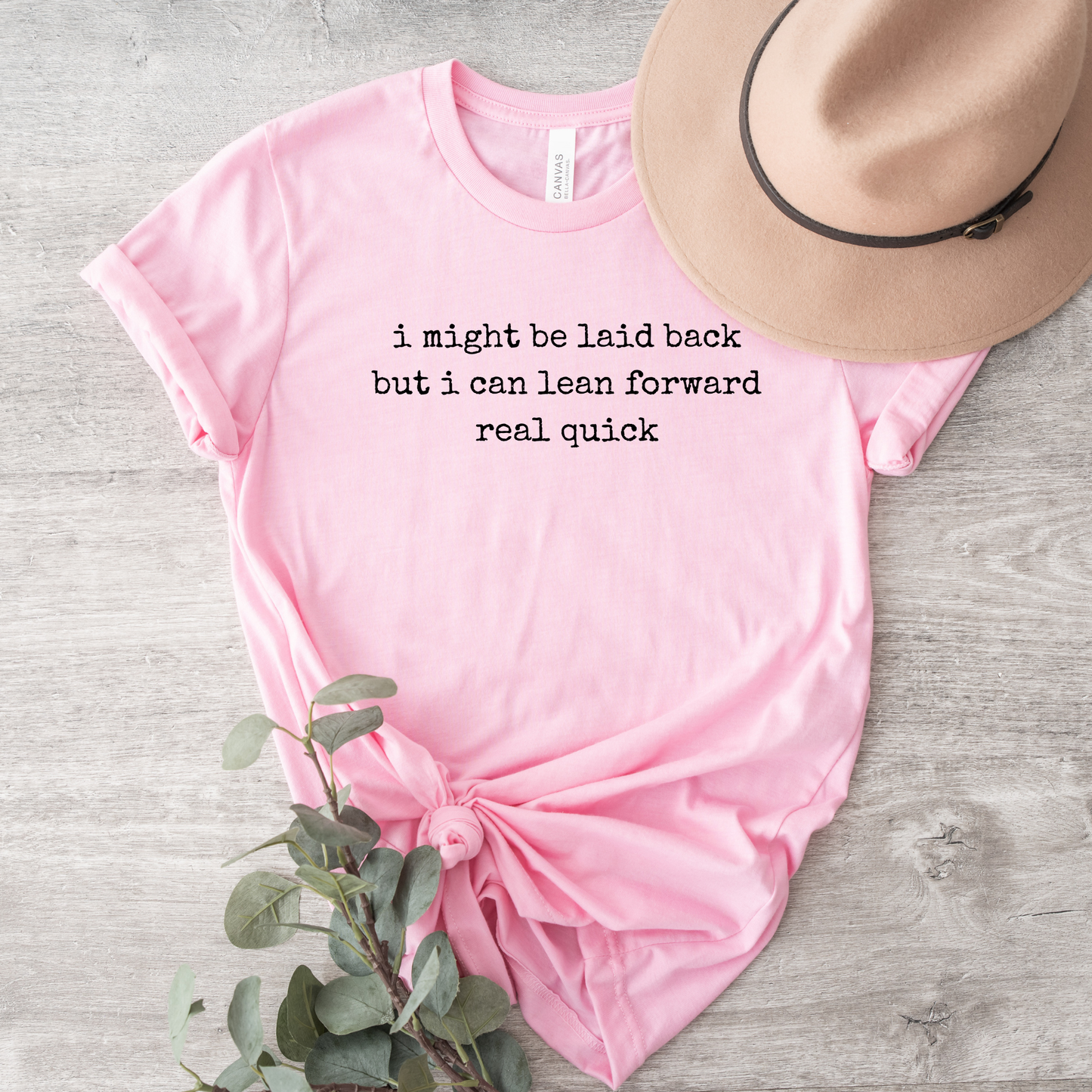 pink t-shirt with a humorous text quote, I might be laid back but I can lean forward real quick shirt, sassy attitude t-shirt, funny motivational tee, unisex humor graphic shirt, quick reaction t-shirt, chill vibe attitude tee, bold typography casual shirt, gym motivation shirt, sarcastic everyday tee, indigenous owned funny shirt, laid back strength apparel, real quick response graphic