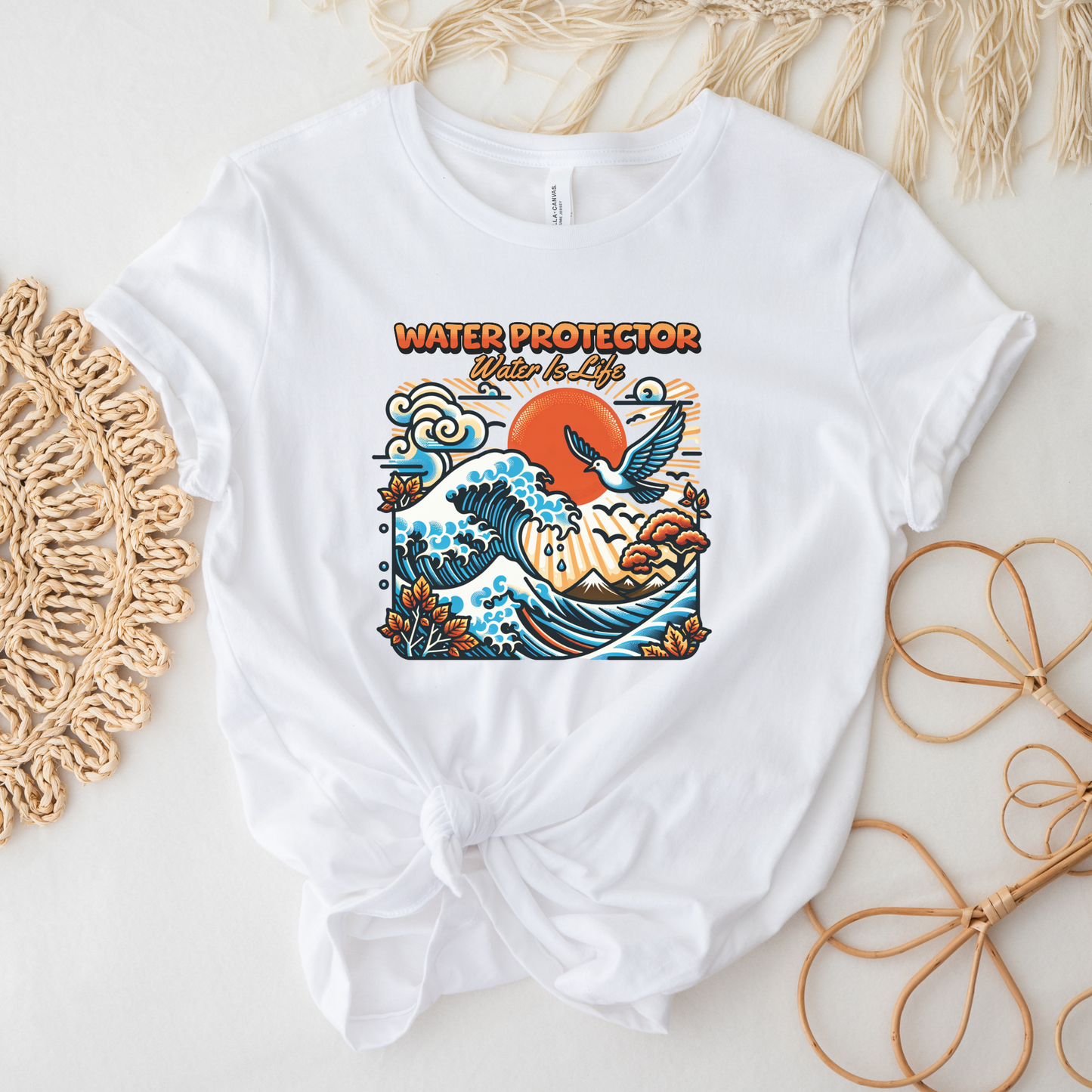 t-shirt featuring a colorful "Water Protector – Water Is Life" graphic with ocean waves, birds, mountains, autumn leaves, and a vibrant sunset, symbolizing environmental stewardship and respect for water. water protector shirt, water is life t-shirt, indigenous environmental apparel, protect our water shirt, environmental awareness tee, sustainability shirt, indigenous advocacy clothing, water stewardship apparel, activist graphic tee, nature lover t-shirt, earth day apparel, eco conscious clothing, environ