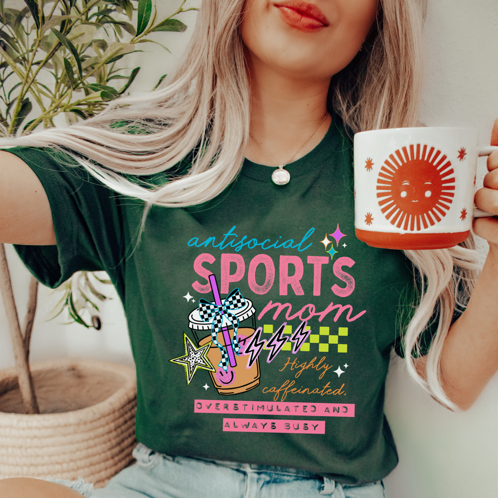 Antisocial Sports Mom Highly Caffeinated Overstimulated And Always Busy shirt with colorful sporty graphic on a unisex tee. antisocial sports mom, sports mom shirt, funny mom tee, caffeinated mom shirt, busy mom apparel, unisex graphic tee, overstimulated mom shirt, sideline mom shirt, coffee mom shirt, statement tee, mom life shirt, everyday casual tee, gift for sports mom, humorous mom shirt, colorful graphic tee