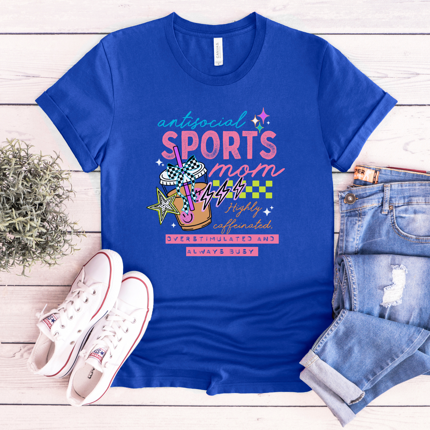 Antisocial Sports Mom Highly Caffeinated Overstimulated And Always Busy shirt with colorful sporty graphic on a unisex tee. antisocial sports mom, sports mom shirt, funny mom tee, caffeinated mom shirt, busy mom apparel, unisex graphic tee, overstimulated mom shirt, sideline mom shirt, coffee mom shirt, statement tee, mom life shirt, everyday casual tee, gift for sports mom, humorous mom shirt, colorful graphic tee