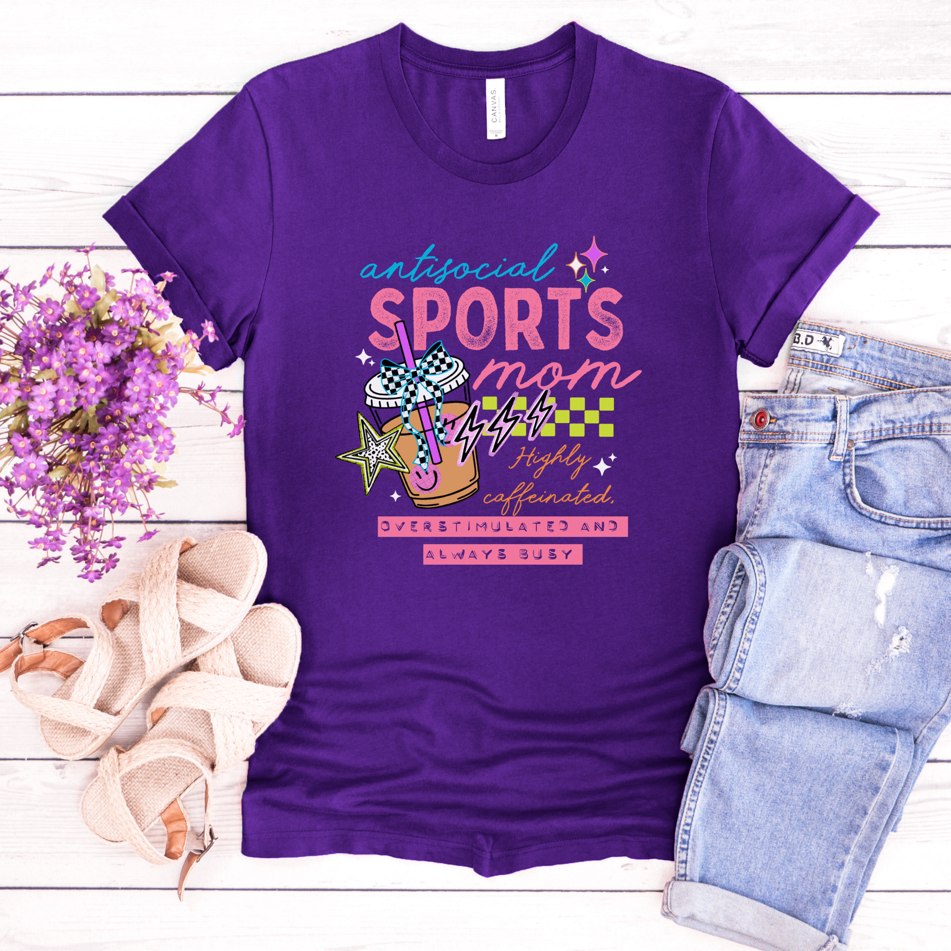 Antisocial Sports Mom Highly Caffeinated Overstimulated And Always Busy shirt with colorful sporty graphic on a unisex tee. antisocial sports mom, sports mom shirt, funny mom tee, caffeinated mom shirt, busy mom apparel, unisex graphic tee, overstimulated mom shirt, sideline mom shirt, coffee mom shirt, statement tee, mom life shirt, everyday casual tee, gift for sports mom, humorous mom shirt, colorful graphic tee