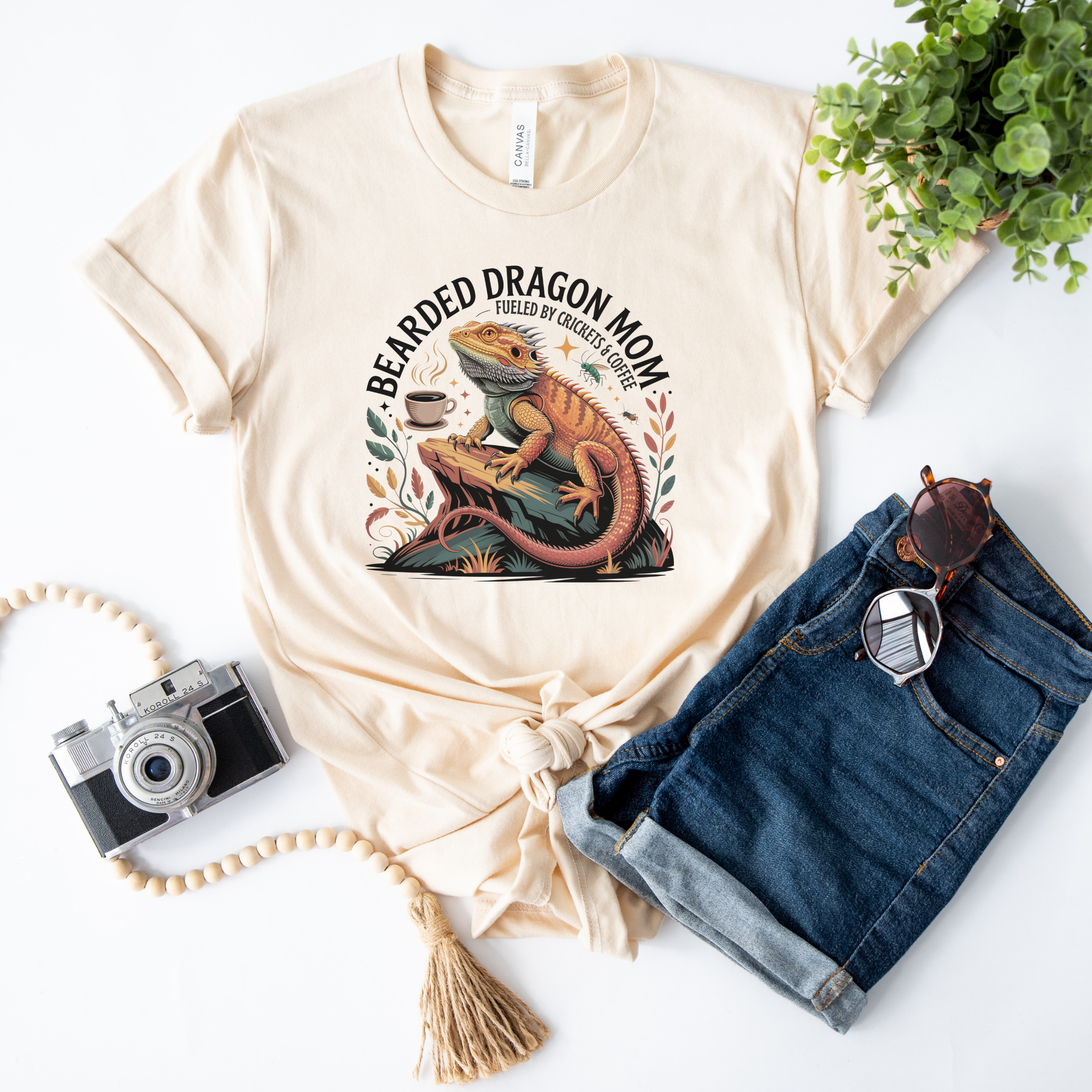 Bearded Dragon Mom Fueled By Crickets and Coffee Shirt featuring a detailed bearded dragon illustration, coffee cup, crickets, and botanical accents. bearded dragon mom shirt, reptile mom shirt, bearded dragon shirt, beardie mom tee, reptile lover shirt, exotic pet shirt, coffee lover shirt, bearded dragon gift, reptile owner gift, lizard shirt, reptile apparel, beardie owner shirt, crickets and coffee shirt, exotic animal lover, pet mom shirt, reptile enthusiast gift, dragon mom shirt, reptile keeper shirt