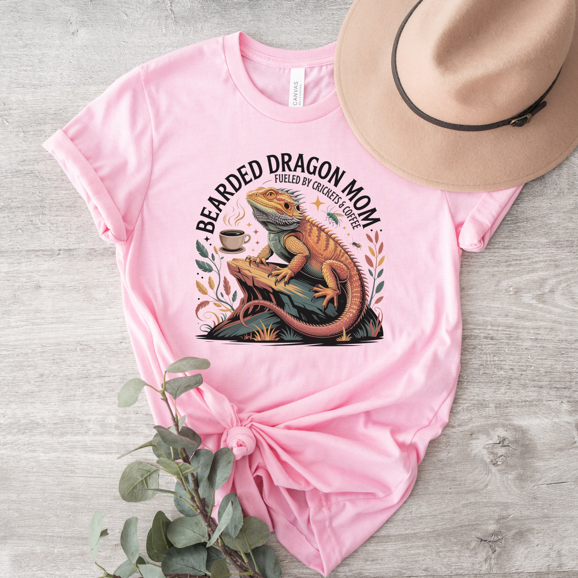 Bearded Dragon Mom Fueled By Crickets and Coffee Shirt featuring a detailed bearded dragon illustration, coffee cup, crickets, and botanical accents. bearded dragon mom shirt, reptile mom shirt, bearded dragon shirt, beardie mom tee, reptile lover shirt, exotic pet shirt, coffee lover shirt, bearded dragon gift, reptile owner gift, lizard shirt, reptile apparel, beardie owner shirt, crickets and coffee shirt, exotic animal lover, pet mom shirt, reptile enthusiast gift, dragon mom shirt, reptile keeper shirt