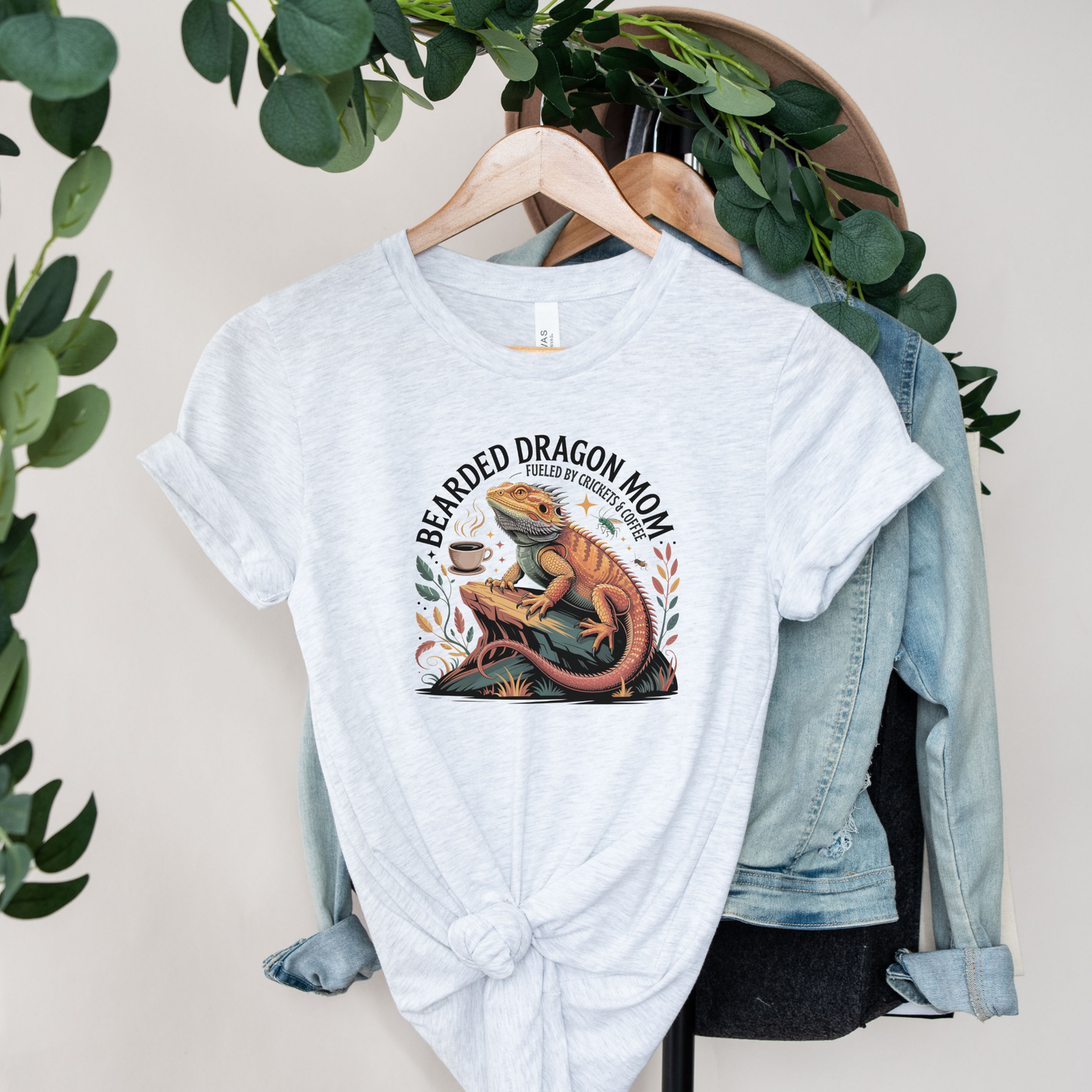 Bearded Dragon Mom Fueled By Crickets and Coffee Shirt featuring a detailed bearded dragon illustration, coffee cup, crickets, and botanical accents. bearded dragon mom shirt, reptile mom shirt, bearded dragon shirt, beardie mom tee, reptile lover shirt, exotic pet shirt, coffee lover shirt, bearded dragon gift, reptile owner gift, lizard shirt, reptile apparel, beardie owner shirt, crickets and coffee shirt, exotic animal lover, pet mom shirt, reptile enthusiast gift, dragon mom shirt, reptile keeper shirt