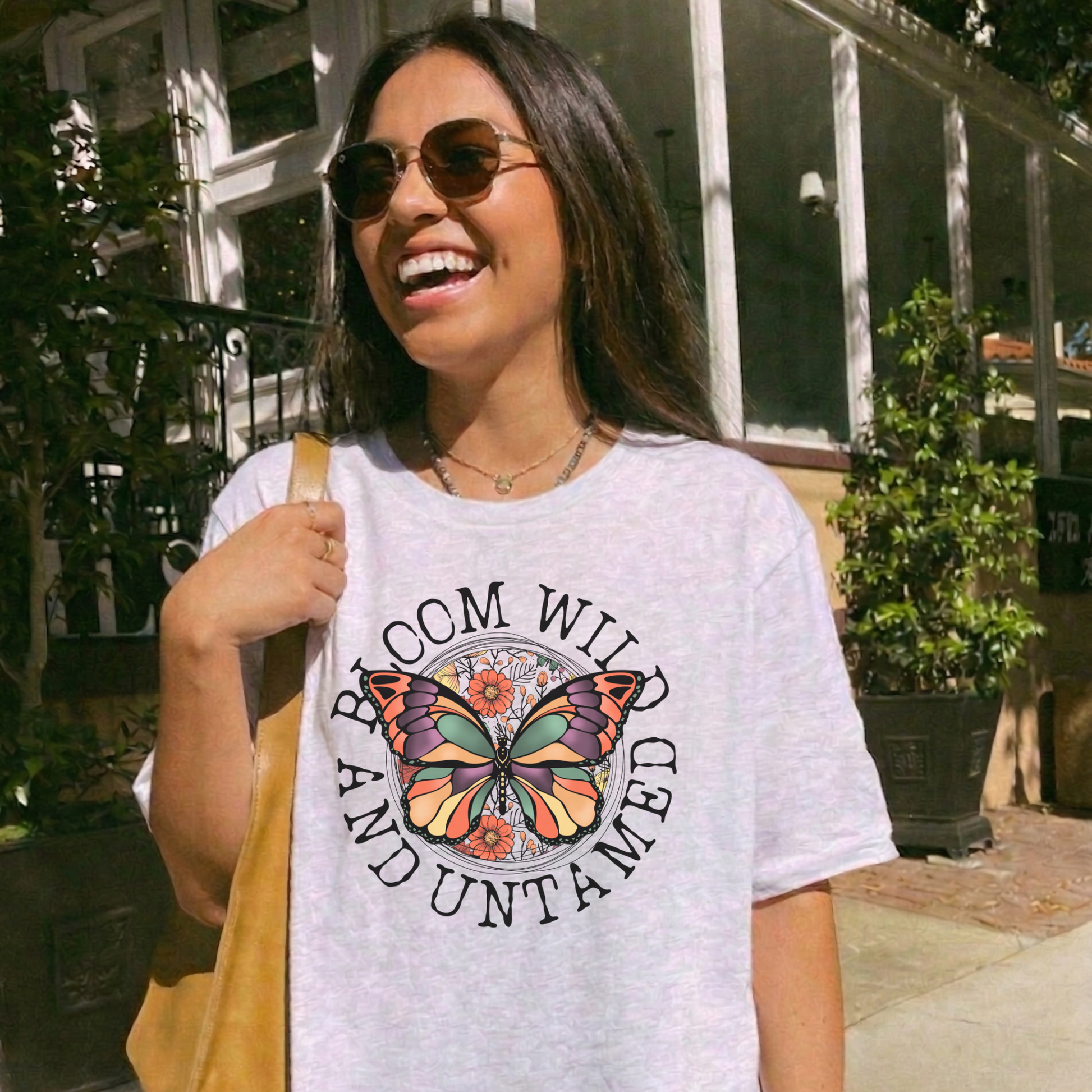 Bloom Wild And Untamed Butterfly shirt with butterfly graphic and inspirational text on a unisex tee. bloom wild and untamed, butterfly shirt, inspirational shirt, nature graphic tee, unisex t shirt, floral butterfly shirt, free spirit shirt, statement tee, everyday graphic tee, gift idea shirt, uplifting apparel, feminine butterfly tee
