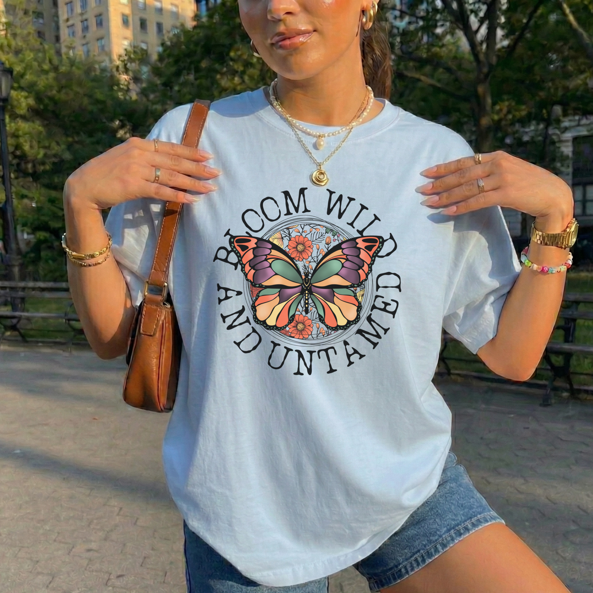 Bloom Wild And Untamed Butterfly shirt with butterfly graphic and inspirational text on a unisex tee. bloom wild and untamed, butterfly shirt, inspirational shirt, nature graphic tee, unisex t shirt, floral butterfly shirt, free spirit shirt, statement tee, everyday graphic tee, gift idea shirt, uplifting apparel, feminine butterfly tee