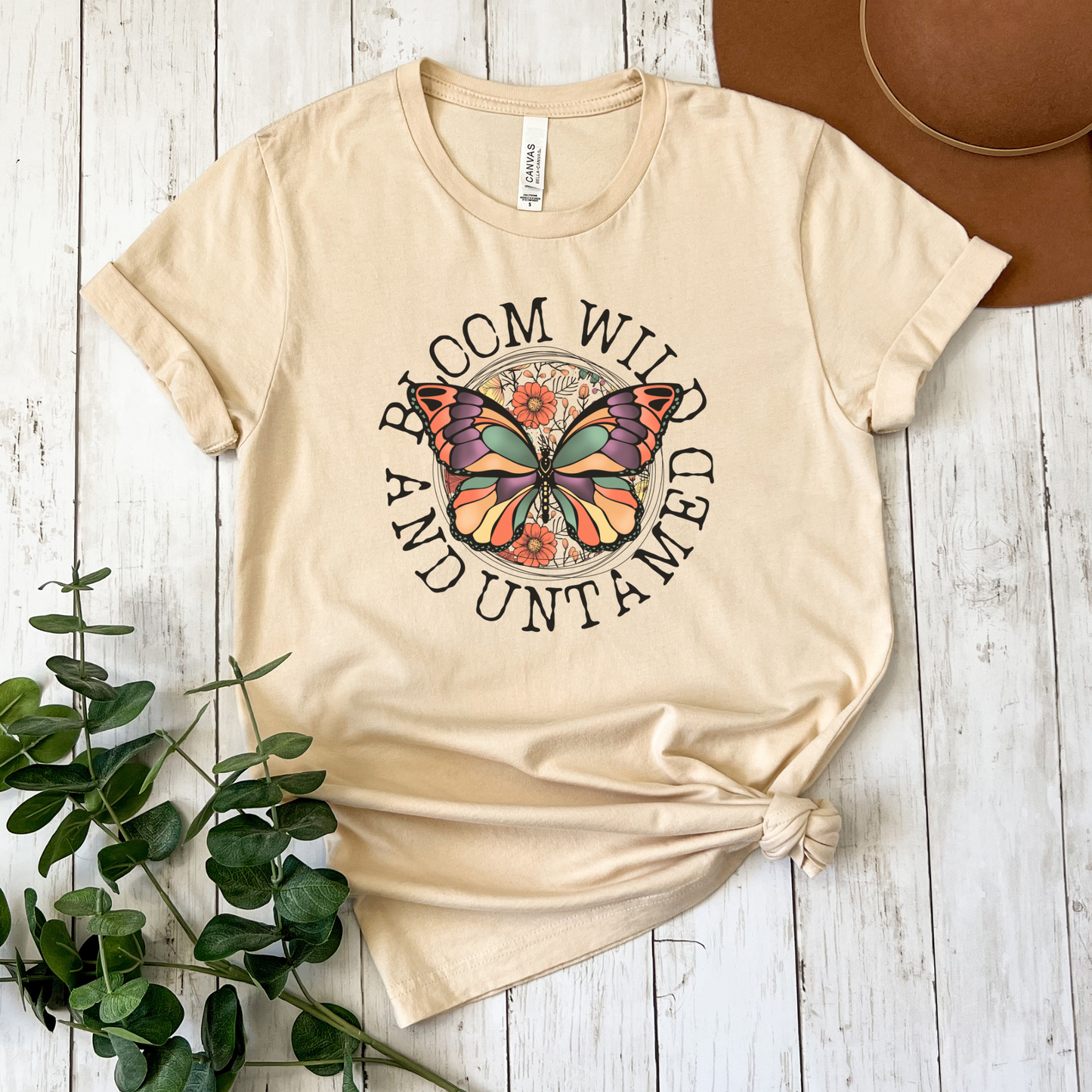 Bloom Wild And Untamed Butterfly shirt with butterfly graphic and inspirational text on a unisex tee. bloom wild and untamed, butterfly shirt, inspirational shirt, nature graphic tee, unisex t shirt, floral butterfly shirt, free spirit shirt, statement tee, everyday graphic tee, gift idea shirt, uplifting apparel, feminine butterfly tee