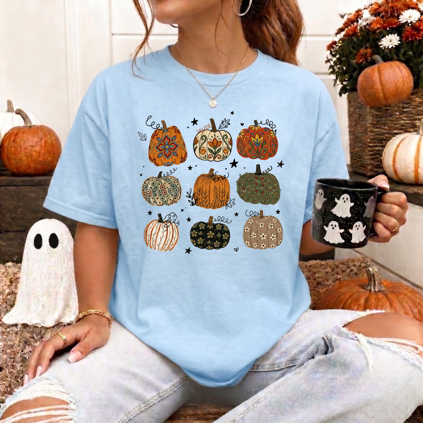 t-shirt featuring nine decorative pumpkins with Indigenous-inspired floral and botanical patterns in warm autumn colors arranged in a grid. indigenous pumpkin shirt, boho pumpkin shirt, fall pumpkin shirt, autumn graphic tee, thanksgiving shirt, indigenous inspired shirt, floral pumpkin shirt, woodland fall shirt, pumpkin patch outfit, harvest shirt, boho fall fashion, cozy autumn tee, fall aesthetic shirt, pumpkin lover gift, autumn apparel, cottagecore fall shirt, botanical pumpkin shirt