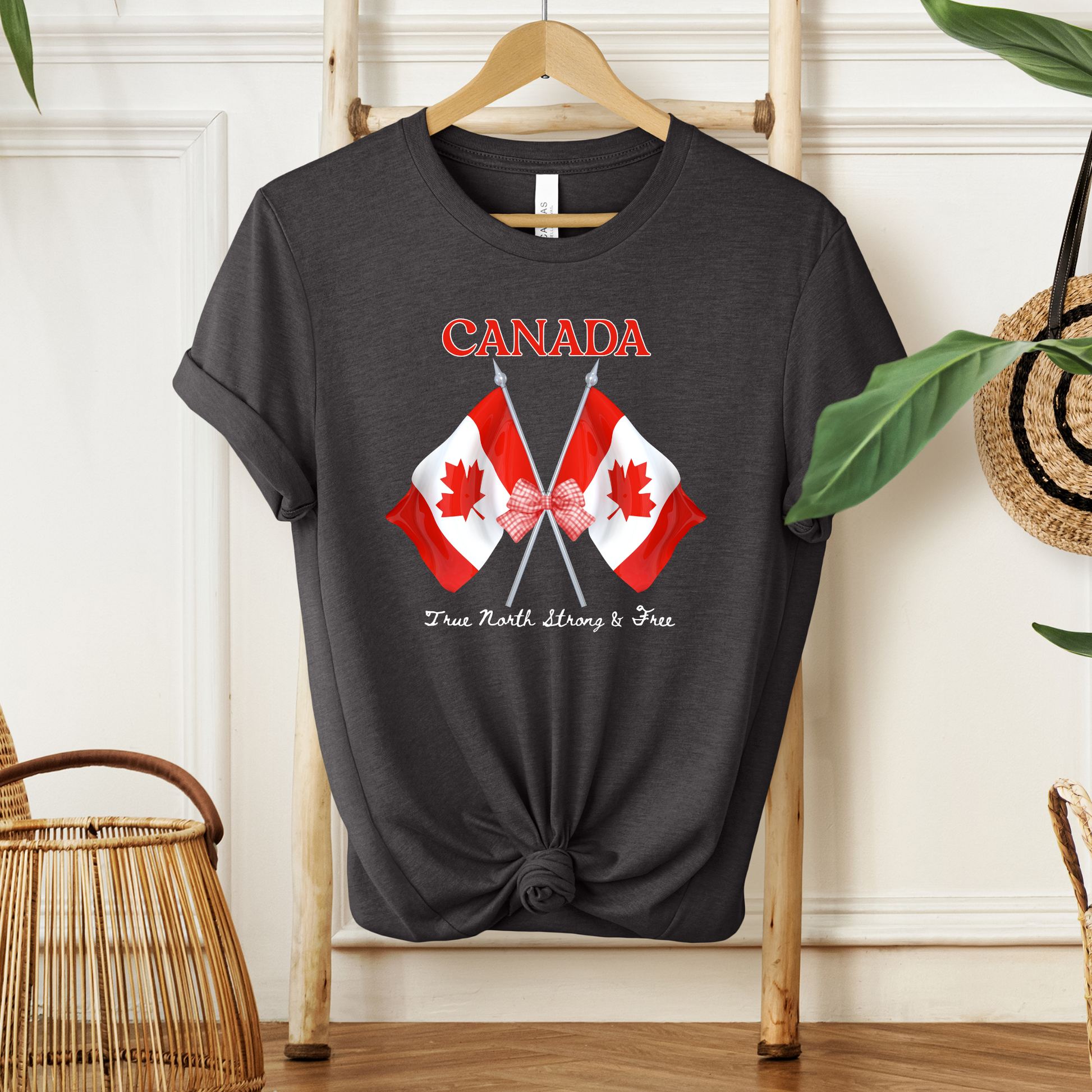 Canada Day Flag Coquette Bow True North Strong and Free Shirt featuring two Canadian flags with a red gingham bow and patriotic Canadian design. canada day shirt, canada shirt, canadian pride shirt, true north strong and free, coquette bow shirt, canada flag shirt, patriotic canada shirt, canada day outfit, canada day apparel, gingham bow shirt, july 1st shirt, canadian clothing, red bow shirt, canada celebration shirt, canadian gift, cute canada shirt, canada day tee, canada flag bow, canada coquette shirt