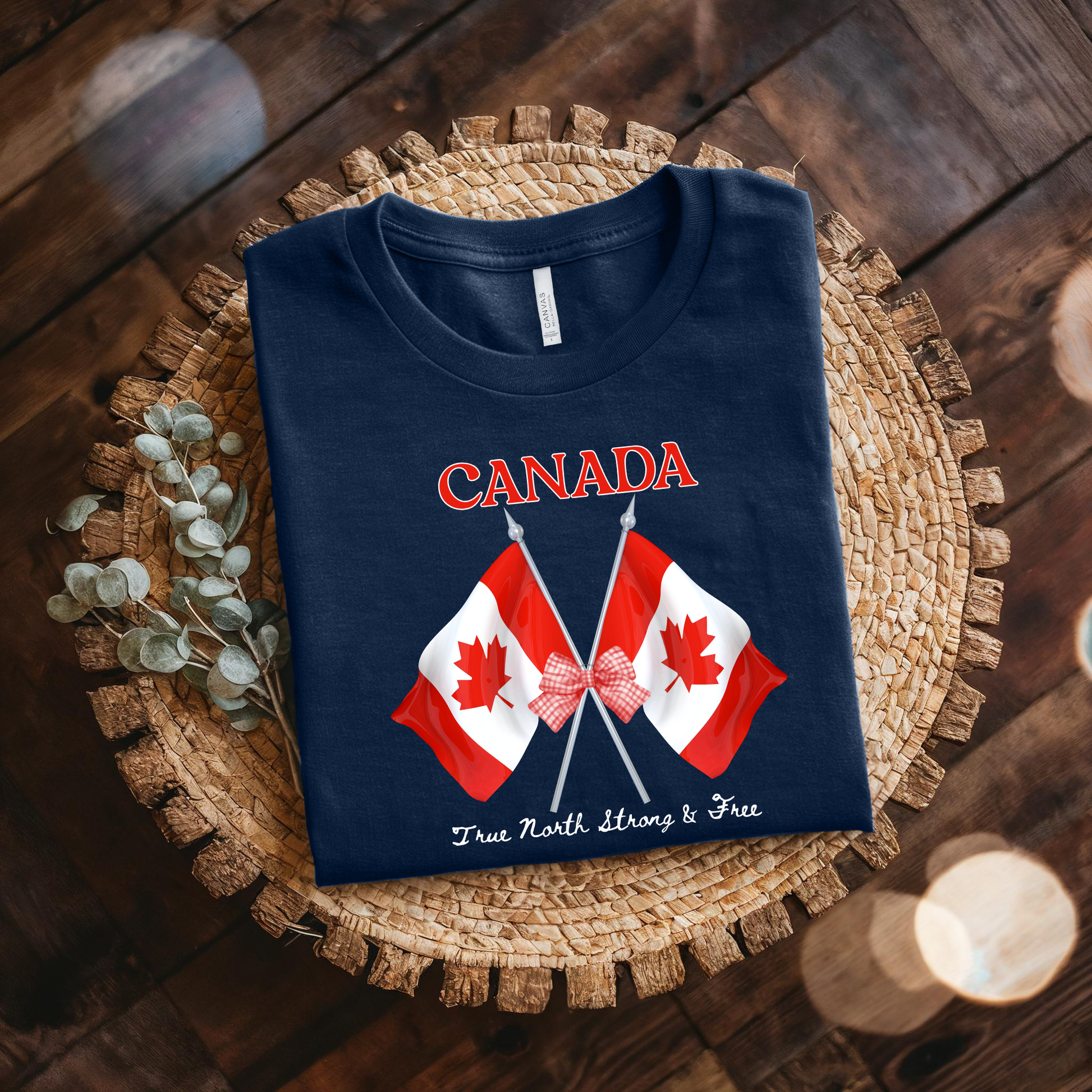 Canada Day Flag Coquette Bow True North Strong and Free Shirt featuring two Canadian flags with a red gingham bow and patriotic Canadian design. canada day shirt, canada shirt, canadian pride shirt, true north strong and free, coquette bow shirt, canada flag shirt, patriotic canada shirt, canada day outfit, canada day apparel, gingham bow shirt, july 1st shirt, canadian clothing, red bow shirt, canada celebration shirt, canadian gift, cute canada shirt, canada day tee, canada flag bow, canada coquette shirt