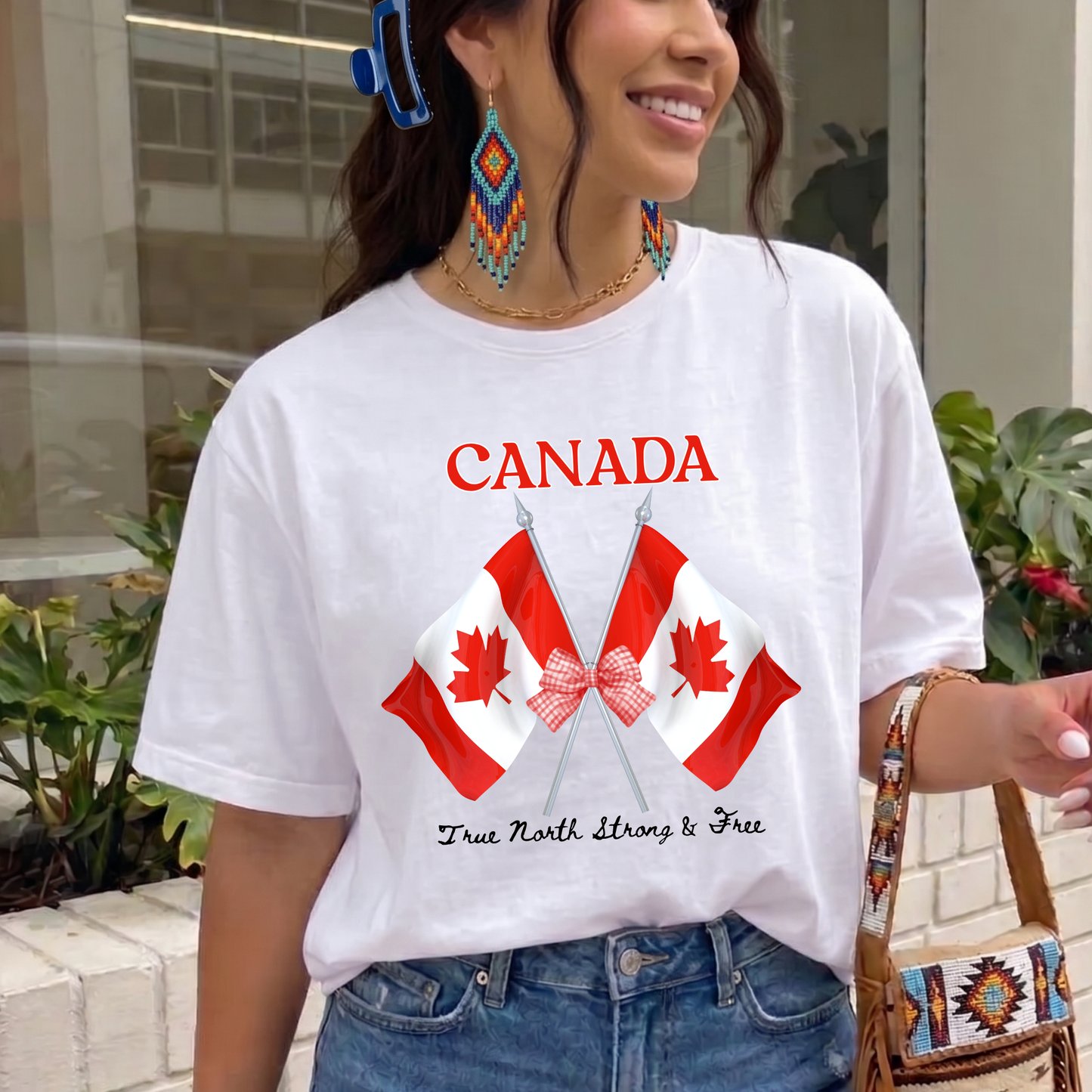 Canada Day Flag Coquette Bow True North Strong and Free Shirt featuring two Canadian flags with a red gingham bow and patriotic Canadian design. canada day shirt, canada shirt, canadian pride shirt, true north strong and free, coquette bow shirt, canada flag shirt, patriotic canada shirt, canada day outfit, canada day apparel, gingham bow shirt, july 1st shirt, canadian clothing, red bow shirt, canada celebration shirt, canadian gift, cute canada shirt, canada day tee, canada flag bow, canada coquette shirt