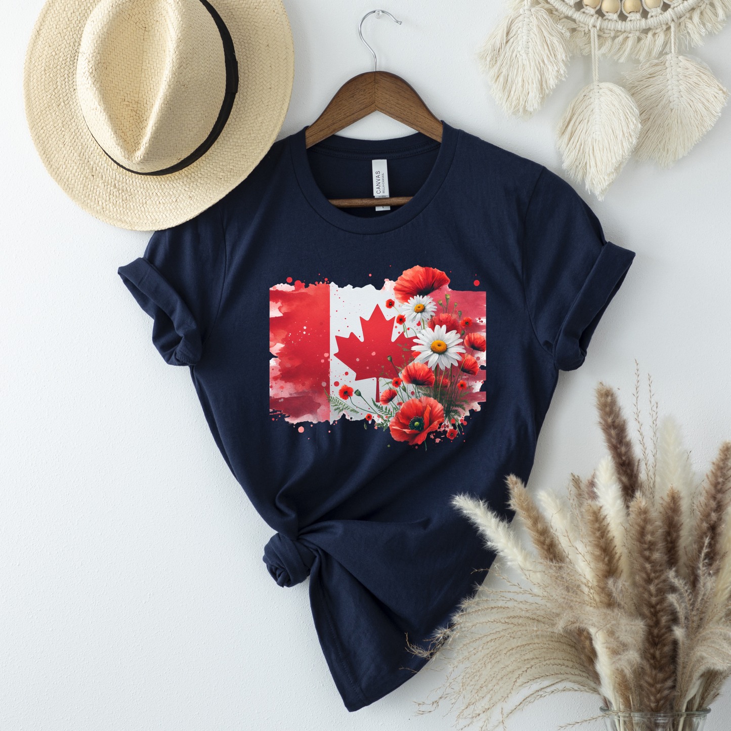 unisex t-shirt featuring a watercolor-style Canadian flag with a red maple leaf surrounded by vibrant red poppies and white daisies, creating a beautiful floral Canada Day design. Canada Day floral shirt, Canadian flag t-shirt, Canada Day graphic tee, patriotic Canada shirt, floral maple leaf shirt, Canadian pride apparel, Canada Day outfit, July 1 clothing, Canadian wildflower shirt, poppy Canada shirt, daisy flag tee, summer Canada shirt, Canadian patriotic clothing, Canada gift ideas, floral Canadian app