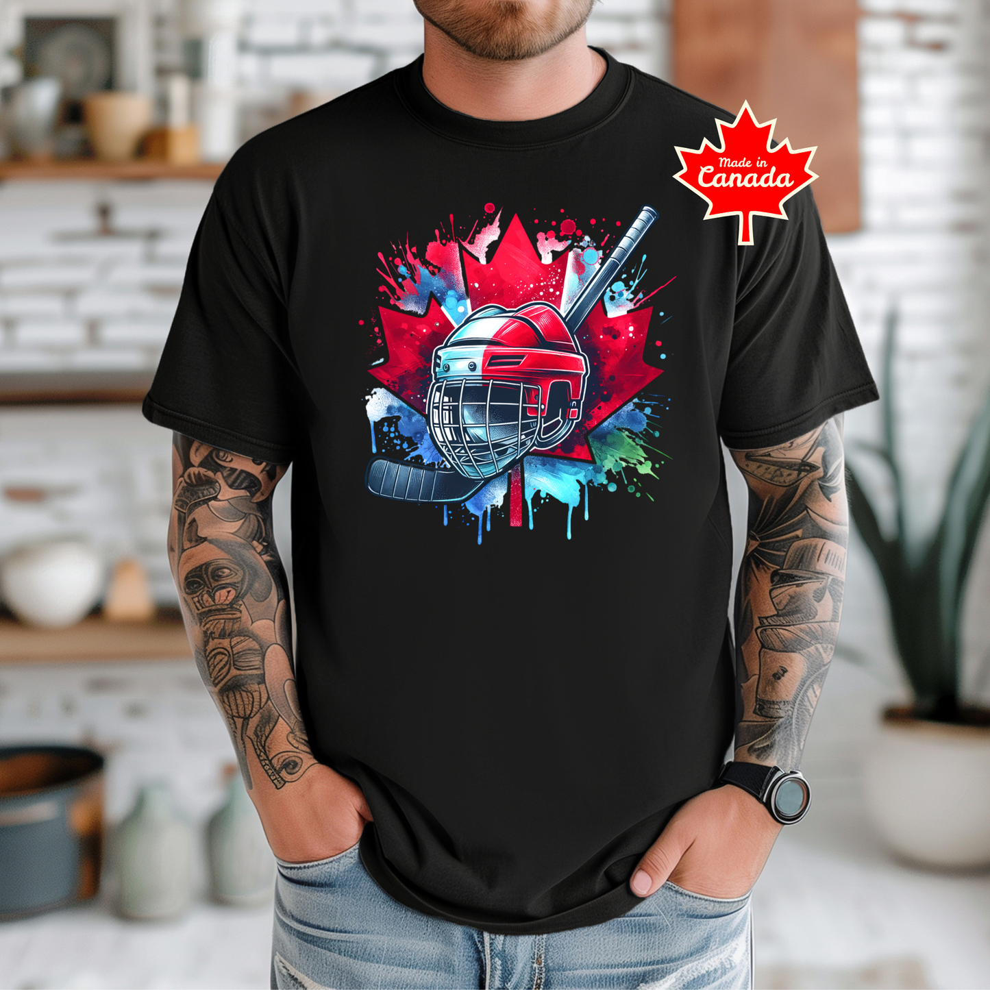 Canada Hockey Shirt featuring a colorful hockey helmet and stick graphic layered over a vibrant red Canadian maple leaf with paint splash accents. Proudly made in Canada, this patriotic hockey t-shirt is perfect for hockey fans, players, coaches, and Canada Day celebrations.