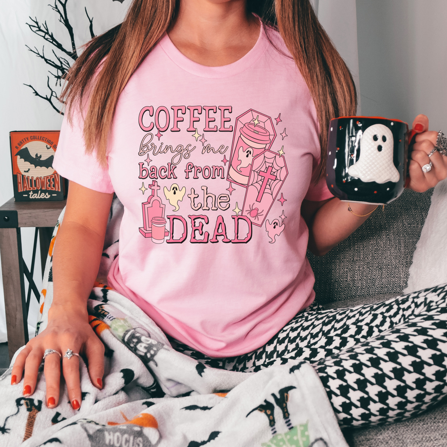 Pink Coffee Brings Me Back From The Dead Shirt featuring cute ghosts, coffee cups, coffins, stars, and spooky aesthetic artwork. coffee shirt, coffee lover shirt, spooky coffee shirt, halloween coffee shirt, ghost shirt, cute ghost shirt, pink halloween shirt, coffee brings me back from the dead, spooky cute shirt, barista shirt, fall shirt, halloween apparel, coffee aesthetic shirt, gothic cute shirt, pink ghost shirt, caffeine lover gift, spooky season shirt, witchy coffee shirt, halloween lover gift