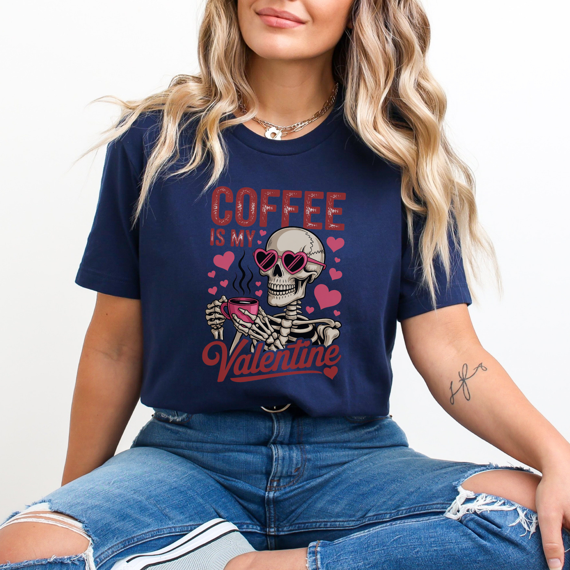 Person wearing a navy blue t-shirt with a skeleton and coffee design, sitting against a plain background. coffee shirt, coffee lover tee, valentine shirt, funny valentine shirt, coffee is my valentine, cute coffee shirt, unisex graphic tee, caffeine shirt, gift for coffee lover, funny t shirt, casual tee, valentines day shirt