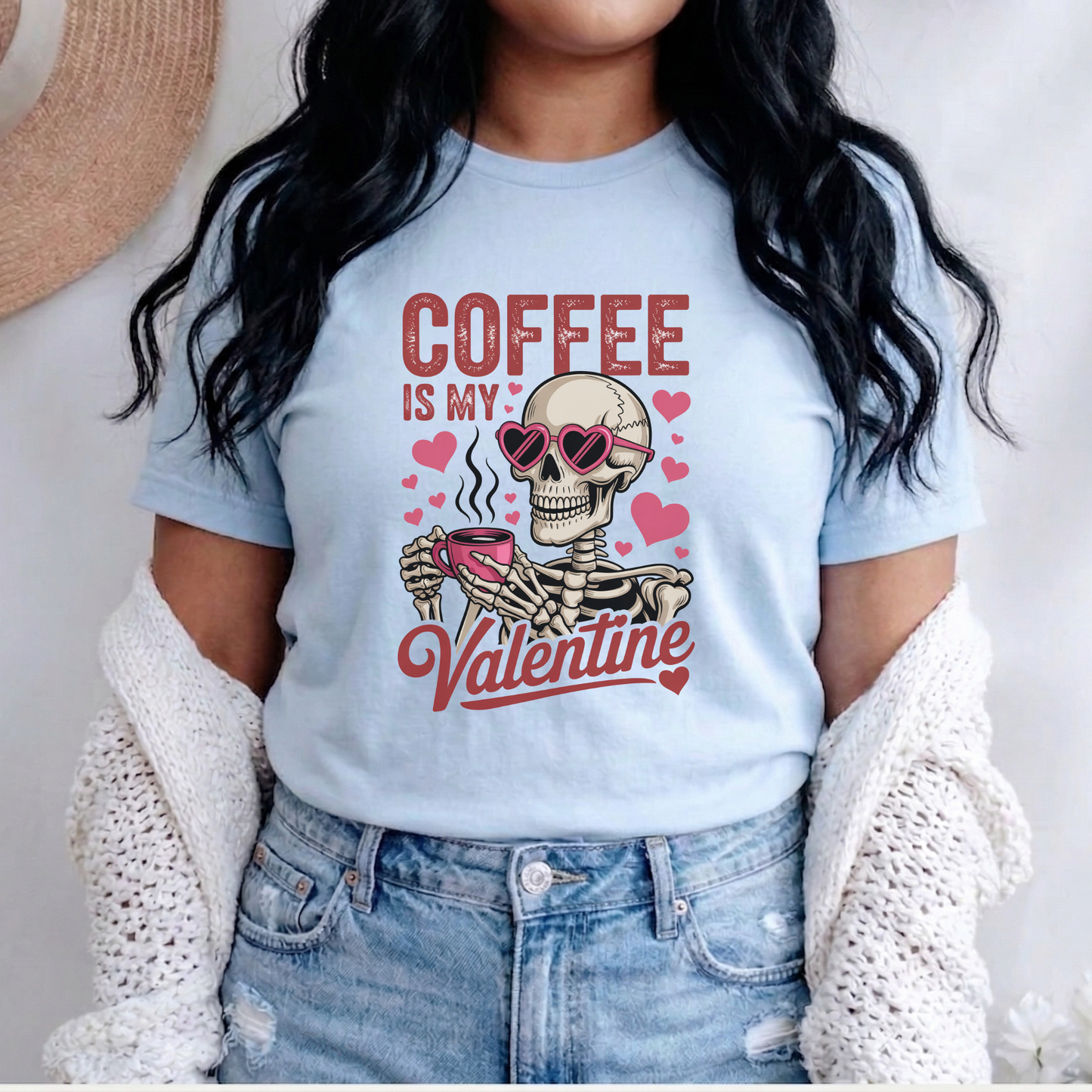 Person wearing a light blue t-shirt with a skeleton holding a coffee cup and text 'Coffee is my Valentine'. coffee shirt, coffee lover tee, valentine shirt, funny valentine shirt, coffee is my valentine, cute coffee shirt, unisex graphic tee, caffeine shirt, gift for coffee lover, funny t shirt, casual tee, valentines day shirt