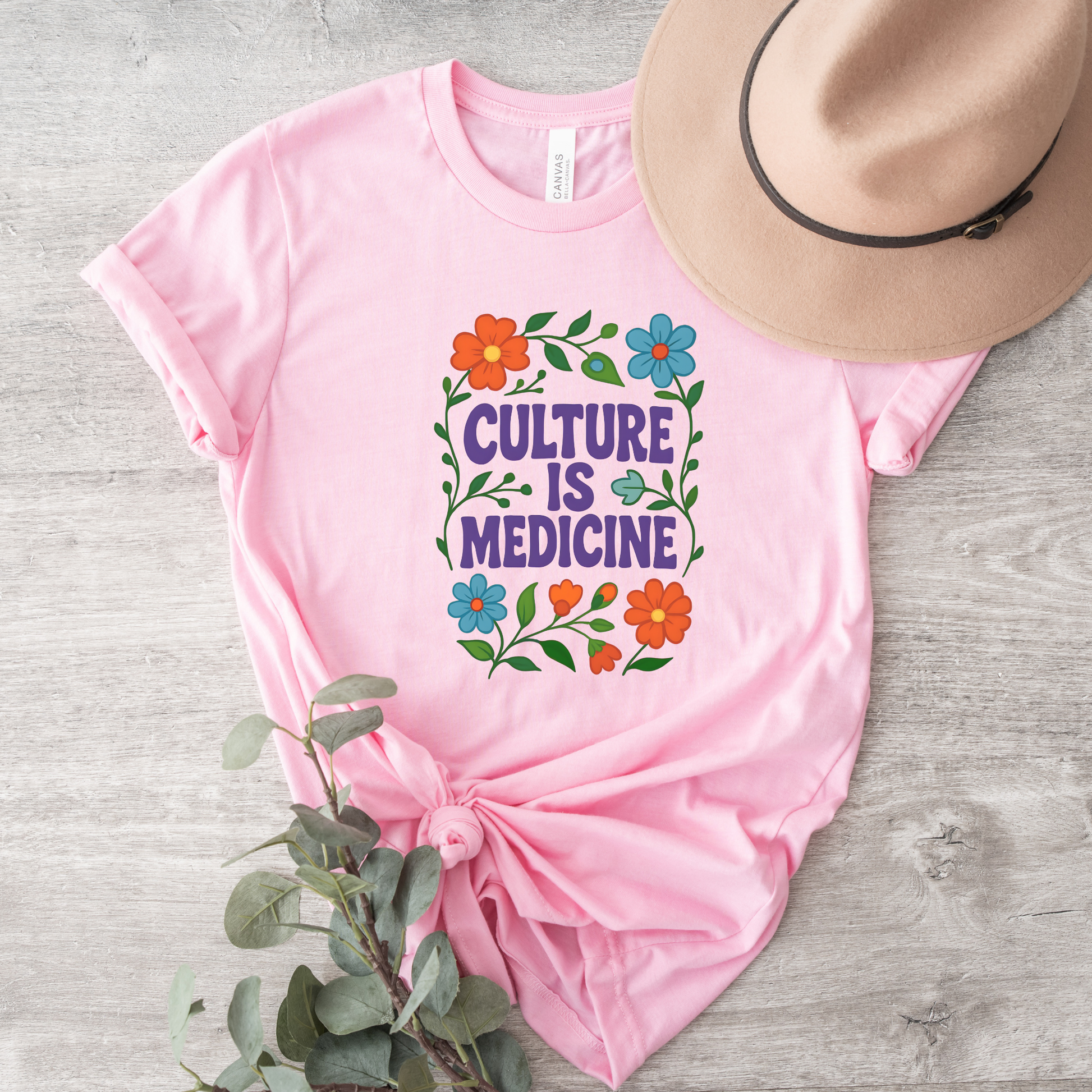 Culture Is Medicine Shirt featuring colorful floral artwork surrounding bold purple lettering. culture is medicine shirt, indigenous shirt, indigenous pride shirt, indigenous apparel, native pride shirt, cultural pride shirt, indigenous history month, national indigenous peoples day, floral shirt, indigenous gift, cultural connection shirt, indigenous woman shirt, reconciliation shirt, indigenous awareness, community shirt, native apparel, indigenous fashion, cultural healing shirt, floral graphic tee