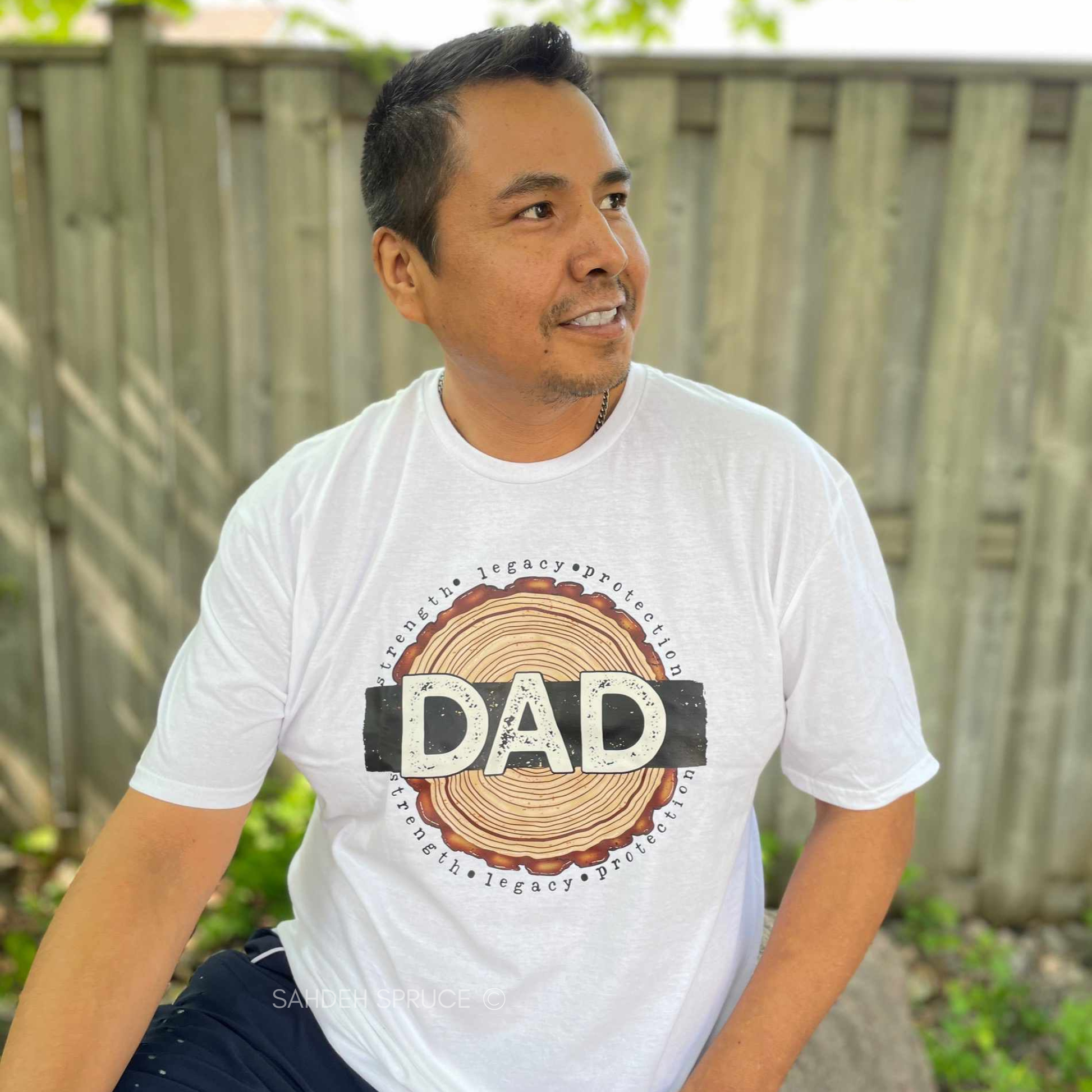 Dad shirt with woodgrain design and the words strength, legacy, protection on a unisex t-shirt. dad shirt, strength legacy protection, father shirt, unisex graphic tee, father’s day shirt, meaningful dad tee, rustic dad shirt, family apparel, dad gift, masculine graphic tee, everyday wear shirt, bold dad design, protective father shirt, legacy shirt, dad lifestyle tee