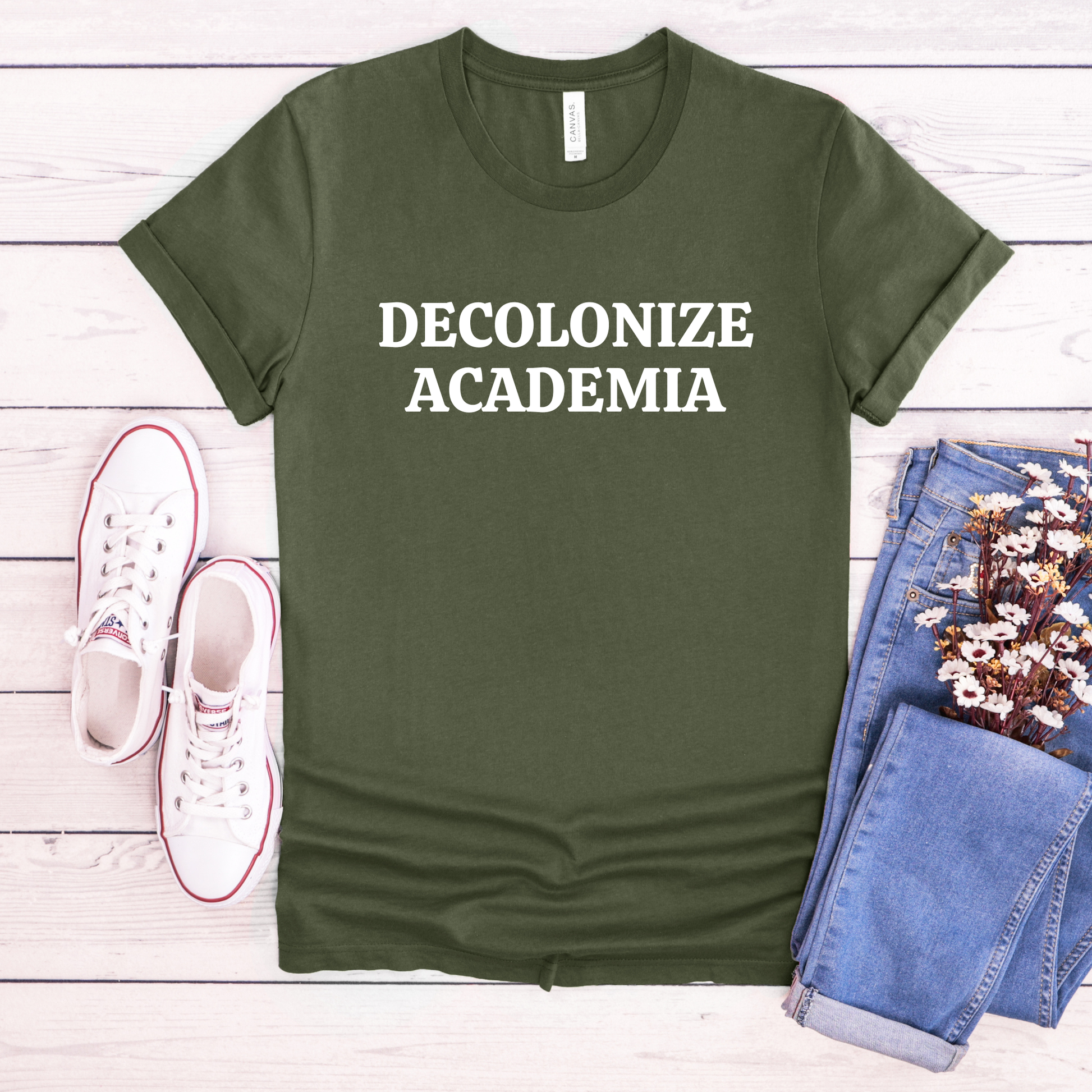 decolonize academia shirt, academic activism shirt, social justice tee, statement graphic tee, unisex protest shirt, educator shirt, student activism apparel, minimalist text shirt, black and white text shirt, inclusive education shirt, campus wear tee, anti colonial shirt, meaningful statement shirt, activism clothing, unisex graphic tee