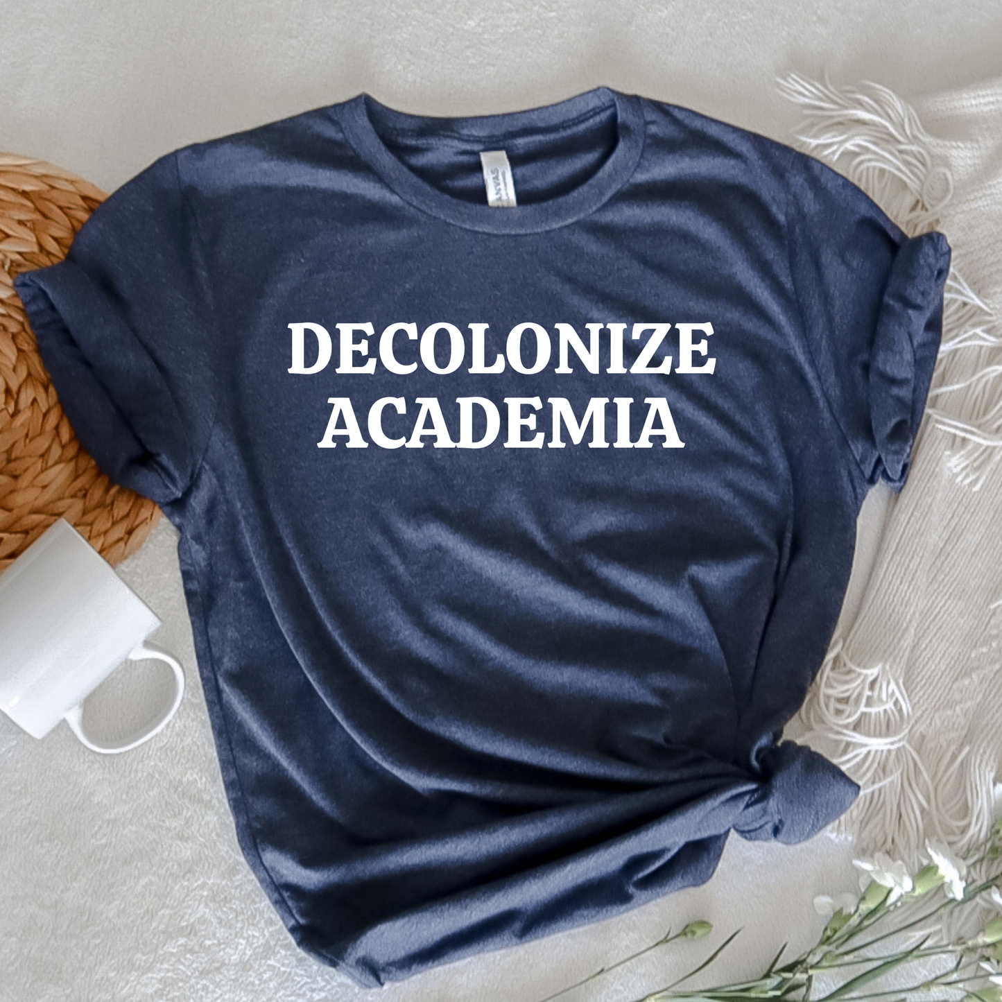 decolonize academia shirt, academic activism shirt, social justice tee, statement graphic tee, unisex protest shirt, educator shirt, student activism apparel, minimalist text shirt, black and white text shirt, inclusive education shirt, campus wear tee, anti colonial shirt, meaningful statement shirt, activism clothing, unisex graphic tee