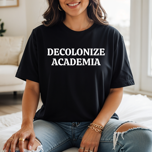 decolonize academia shirt, academic activism shirt, social justice tee, statement graphic tee, unisex protest shirt, educator shirt, student activism apparel, minimalist text shirt, black and white text shirt, inclusive education shirt, campus wear tee, anti colonial shirt, meaningful statement shirt, activism clothing, unisex graphic tee