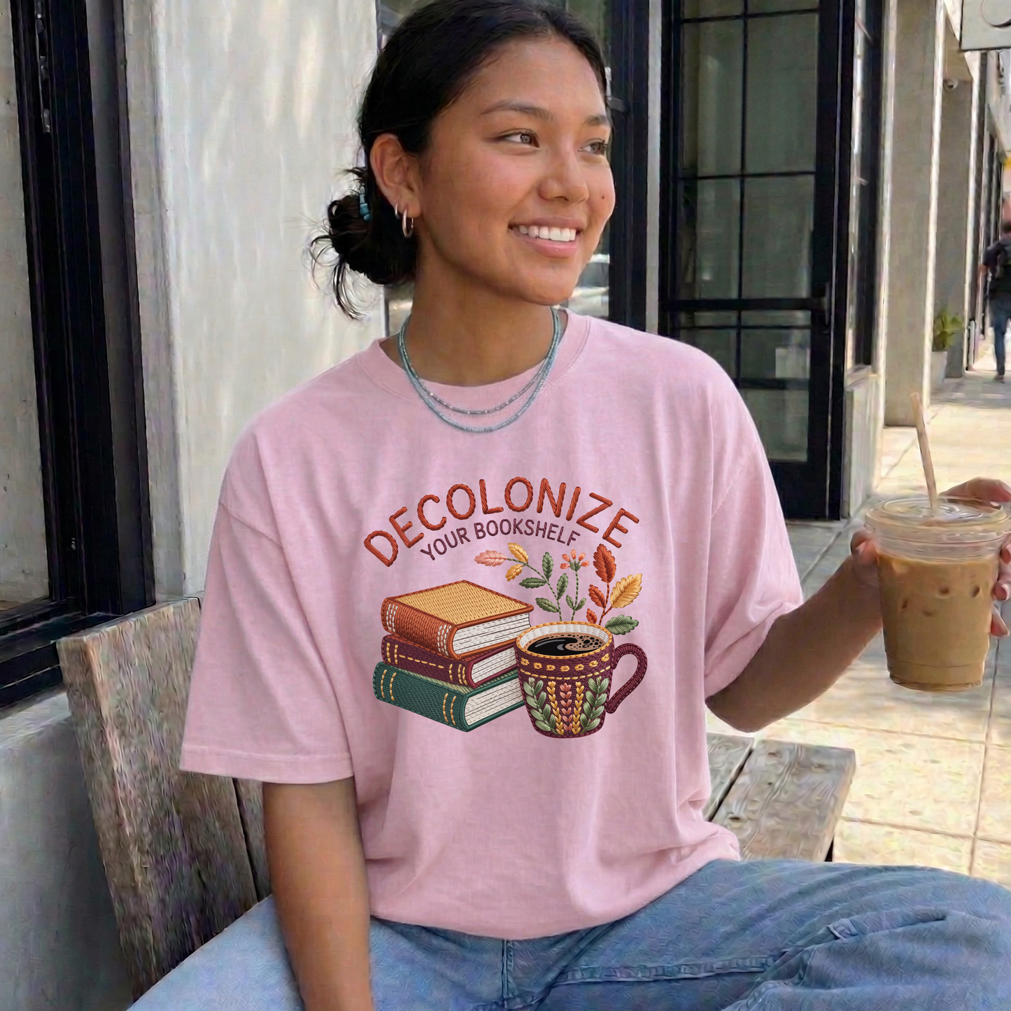Decolonize Your Bookshelf Shirt featuring stacked books, a floral coffee mug, botanical accents, and embroidered-style lettering. decolonize your bookshelf shirt, book lover shirt, reader shirt, librarian shirt, teacher shirt, bookworm shirt, reading shirt, book club shirt, diverse books shirt, indigenous literature, bookstore shirt, coffee and books, literary shirt, reader gift, librarian gift, teacher gift, book aesthetic shirt, bookish apparel, reading enthusiast, book nerd shirt