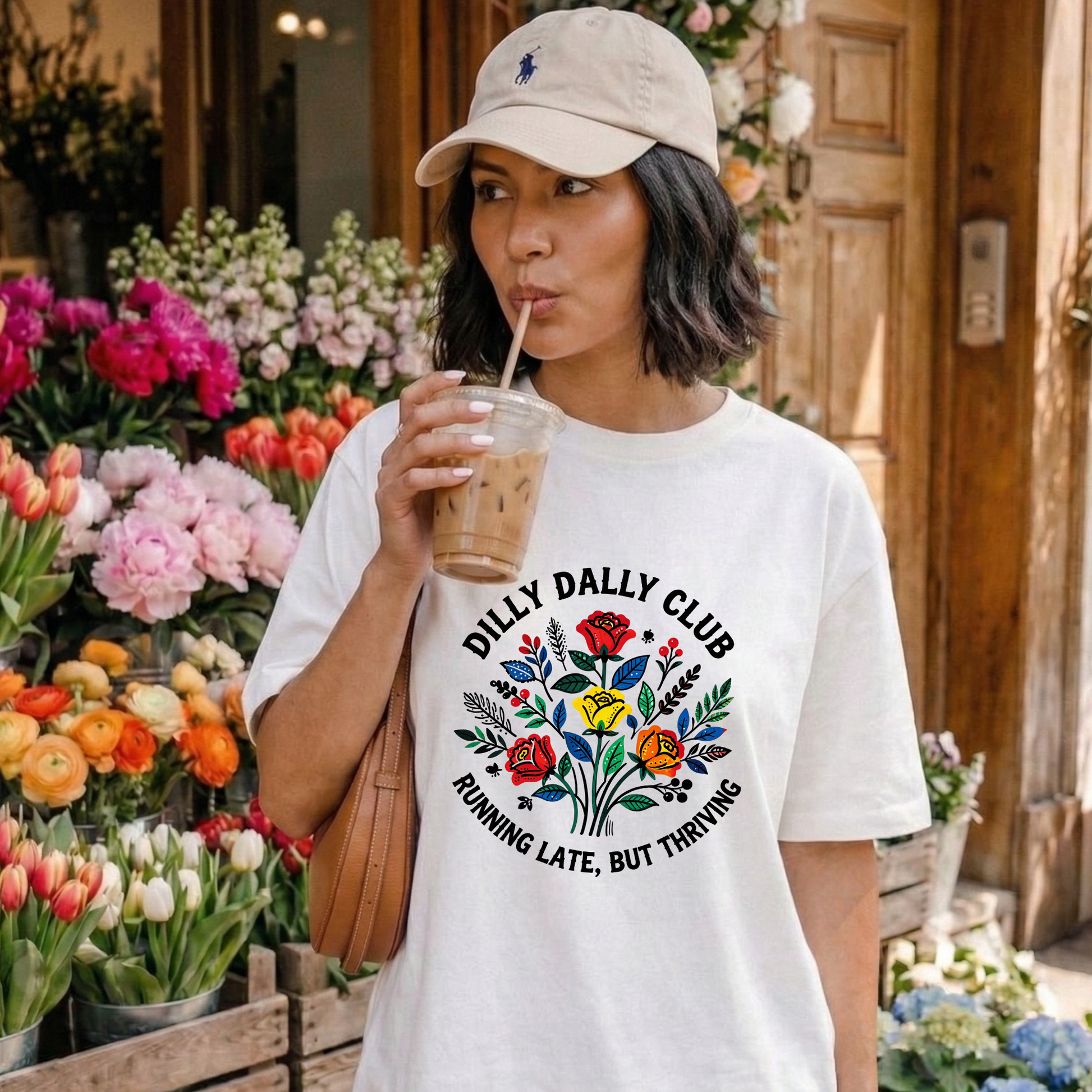 Dilly Dally Club Running Late, But Thriving shirt design featuring colorful woodland-inspired floral artwork with red, yellow, orange, blue, and green flowers arranged in a bouquet. Circular text reads 'Dilly Dally Club' and 'Running Late, But Thriving' on a transparent background. Dilly Dally Club, Running Late But Thriving, Woodland Floral, Floral Shirt, Graphic Tee, Funny Shirt, Unisex Tee, Floral Graphic Tee, Indigenous Inspired, Botanical Shirt, Cottagecore Fashion, Colorful Shirt, Gift For Her