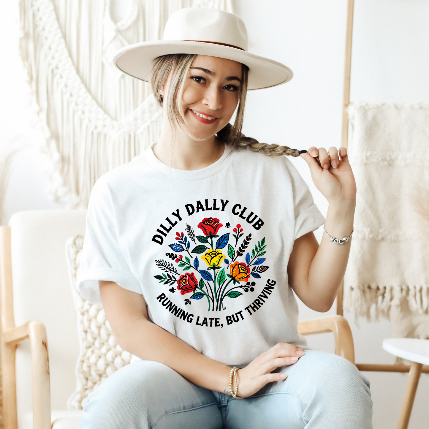 Dilly Dally Club Running Late, But Thriving shirt design featuring colorful woodland-inspired floral artwork with red, yellow, orange, blue, and green flowers arranged in a bouquet. Circular text reads 'Dilly Dally Club' and 'Running Late, But Thriving' on a transparent background. Dilly Dally Club, Running Late But Thriving, Woodland Floral, Floral Shirt, Graphic Tee, Funny Shirt, Unisex Tee, Floral Graphic Tee, Indigenous Inspired, Botanical Shirt, Cottagecore Fashion, Colorful Shirt, Gift For Her