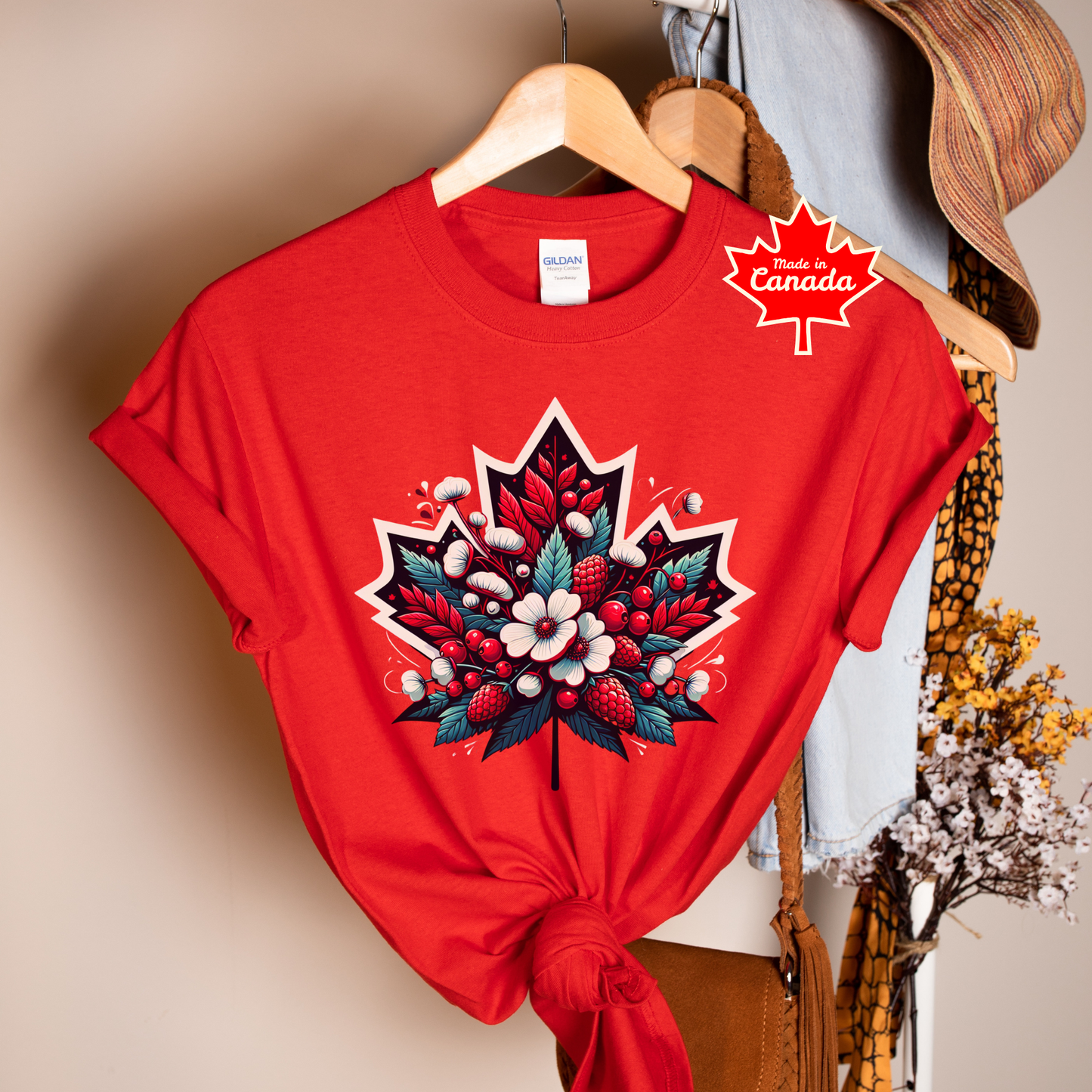 Red Canada Day shirt featuring a maple leaf filled with flowers, berries, and botanical elements inspired by Canada's natural beauty. Floral Canada Flag Shirt, Canada Day Shirt, Maple Leaf Floral Shirt, Canadian Pride Shirt, Made in Canada Apparel, Canada Graphic Tee, Botanical Maple Leaf Shirt, Berry Floral Shirt, Canadian Nature Shirt, Canada Day Clothing