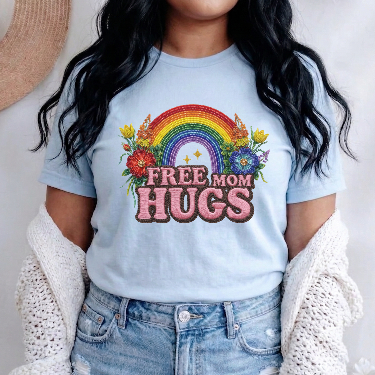 Free Mom Hugs Shirt featuring Indigenous-inspired beaded floral artwork, rainbow design, and pink faux embroidered lettering. free mom hugs shirt, pride shirt, indigenous floral shirt, beaded floral shirt, rainbow pride shirt, lgbtq ally shirt, supportive mom shirt, pride parade shirt, indigenous inspired apparel, faux embroidery shirt, mom hugs shirt, rainbow floral tee, inclusive apparel, pride month shirt, indigenous beadwork design, ally gift, lgbtq support shirt, community love shirt, acceptance shirt
