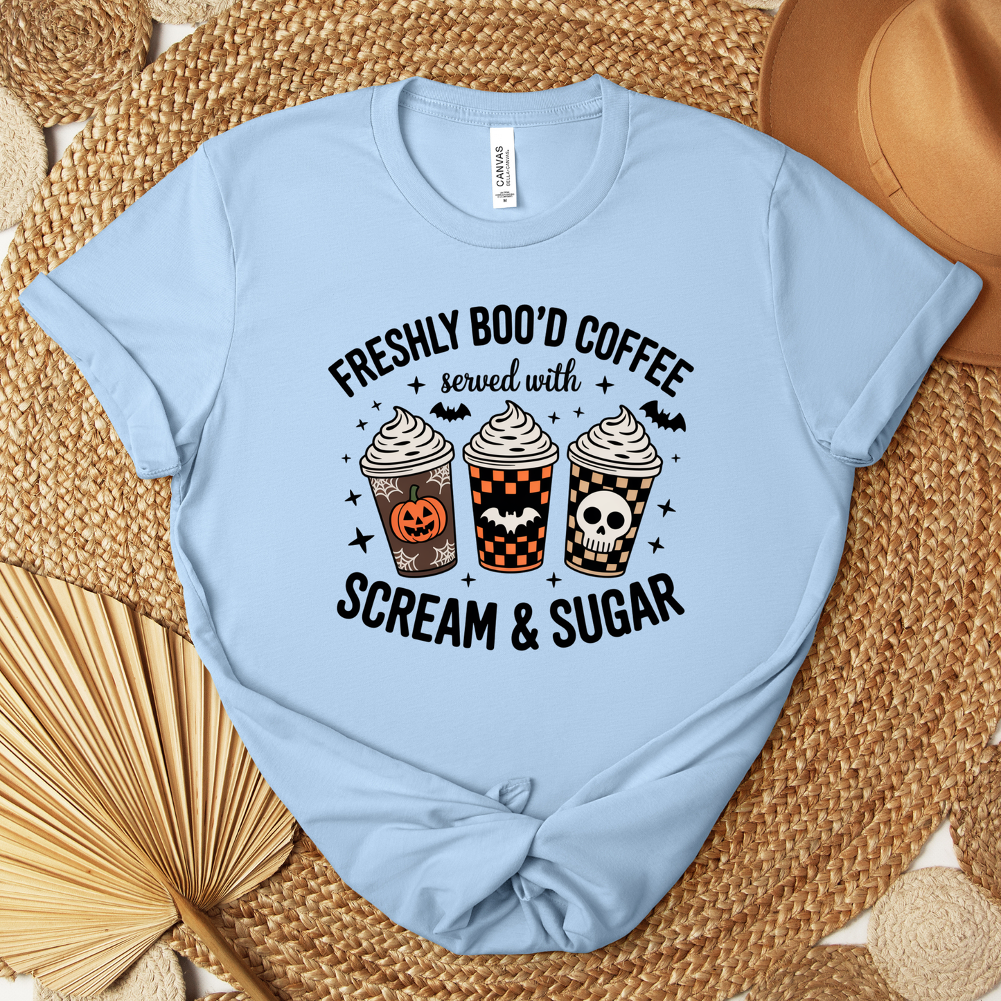 Funny Halloween coffee shirt featuring three festive coffee cups with pumpkins, bats, checkerboard patterns, and skull artwork that reads "Freshly Boo'd Coffee Served With Scream & Sugar." freshly boo'd coffee shirt, scream and sugar shirt, halloween coffee shirt, spooky coffee shirt, coffee lover halloween shirt, pumpkin spice shirt, fall coffee shirt, cute halloween tee, halloween graphic tee, spooky season shirt, pumpkin patch outfit, coffee addict shirt, funny coffee shirt, halloween apparel