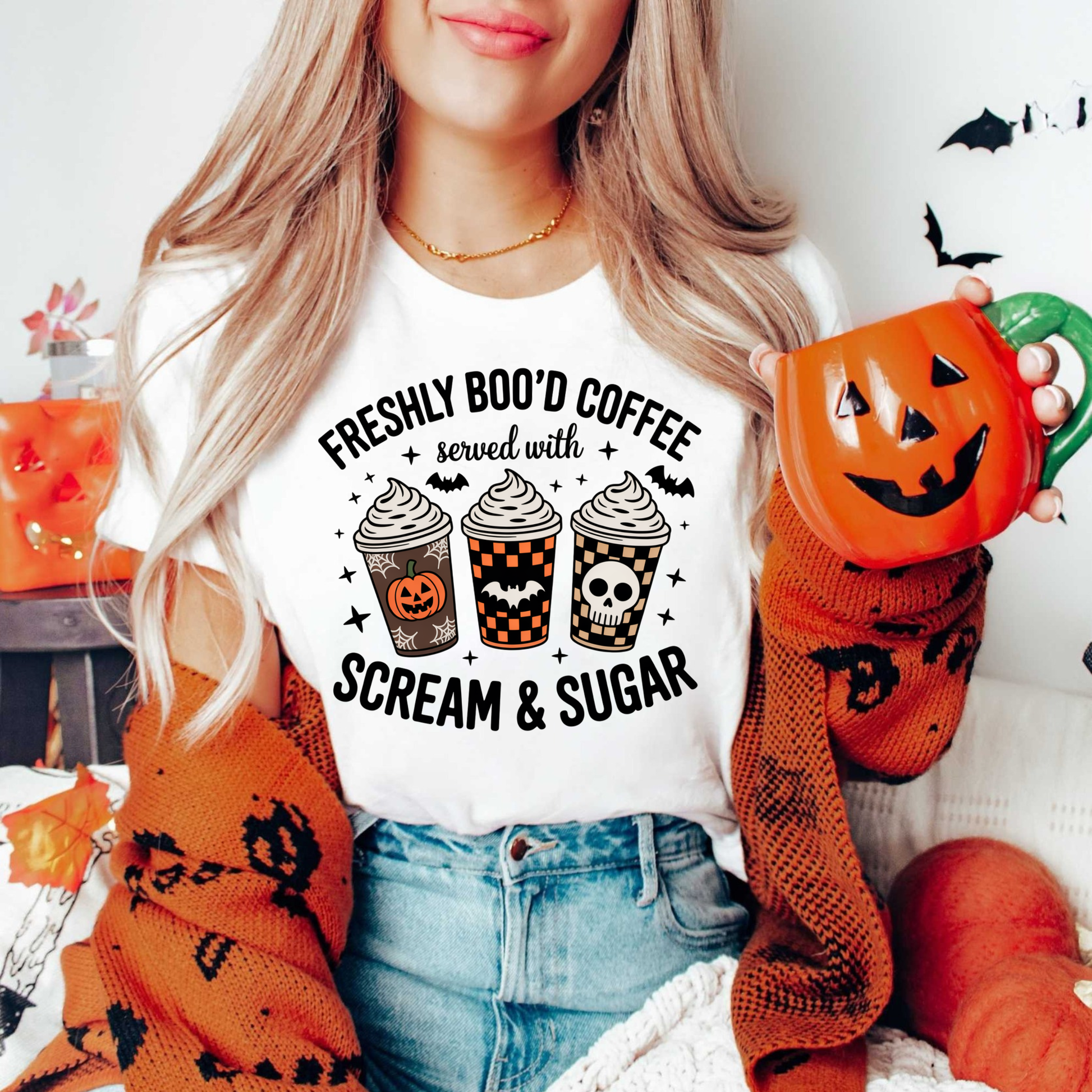Funny Halloween coffee shirt featuring three festive coffee cups with pumpkins, bats, checkerboard patterns, and skull artwork that reads "Freshly Boo'd Coffee Served With Scream & Sugar." freshly boo'd coffee shirt, scream and sugar shirt, halloween coffee shirt, spooky coffee shirt, coffee lover halloween shirt, pumpkin spice shirt, fall coffee shirt, cute halloween tee, halloween graphic tee, spooky season shirt, pumpkin patch outfit, coffee addict shirt, funny coffee shirt, halloween apparel