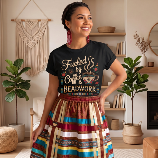 Fueled by Coffee and Beadwork Shirt featuring an Indigenous-inspired beaded coffee mug, floral artwork, and decorative accents designed by an Indigenous artist at Sahdeh Spruce. fueled by coffee and beadwork shirt, beadwork shirt, indigenous beadwork shirt, indigenous coffee shirt, coffee lover shirt, beader shirt, bead artist shirt, indigenous artist apparel, sahdeh spruce, indigenous owned business, indigenous clothing, beaded coffee mug shirt, native beadwork 