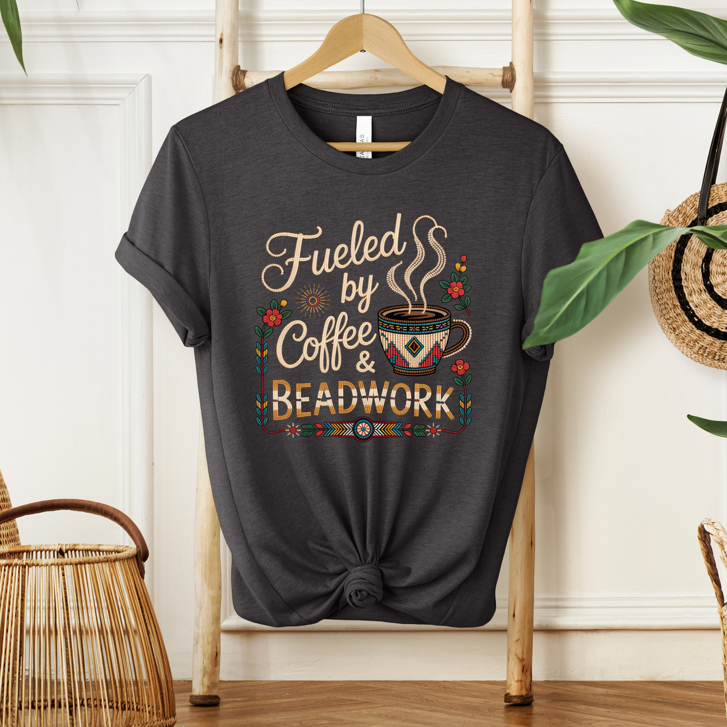 Fueled by Coffee and Beadwork Shirt featuring an Indigenous-inspired beaded coffee mug, floral artwork, and decorative accents designed by an Indigenous artist at Sahdeh Spruce. fueled by coffee and beadwork shirt, beadwork shirt, indigenous beadwork shirt, indigenous coffee shirt, coffee lover shirt, beader shirt, bead artist shirt, indigenous artist apparel, sahdeh spruce, indigenous owned business, indigenous clothing, beaded coffee mug shirt, native beadwork 