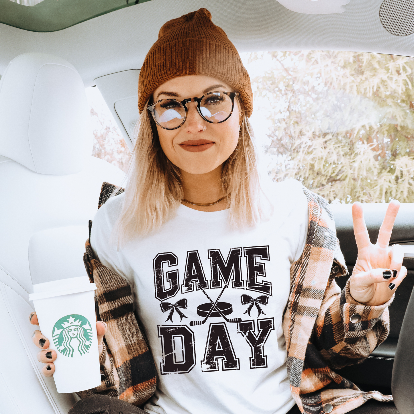 t-shirt featuring distressed varsity lettering that reads "Game Day" with crossed hockey sticks, a puck, and coquette bow accents in a vintage-inspired hockey graphic. game day hockey shirt, hockey coquette shirt, hockey mom shirt, hockey game day tee, bow hockey shirt, hockey girlfriend shirt, hockey sister shirt, hockey fan apparel, varsity hockey shirt, distressed hockey tee, hockey season shirt, hockey lover gift, cute hockey shirt, sports mom shirt, hockey tournament outfit, ice hockey shirt, coquette 