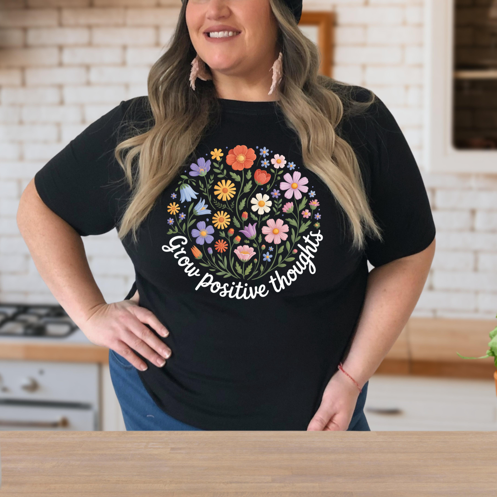  t-shirt featuring a colorful wildflower bouquet design with the inspirational phrase "Grow Positive Thoughts" in white script lettering. grow positive thoughts shirt, positive thoughts t-shirt, inspirational floral shirt, positive mindset apparel, wildflower graphic tee, motivational t-shirt, floral quote shirt, positive vibes clothing, botanical shirt, gardener gift ideas, nature lover t-shirt, self care apparel, inspirational gift for women, uplifting graphic tee, floral aesthetic clothing