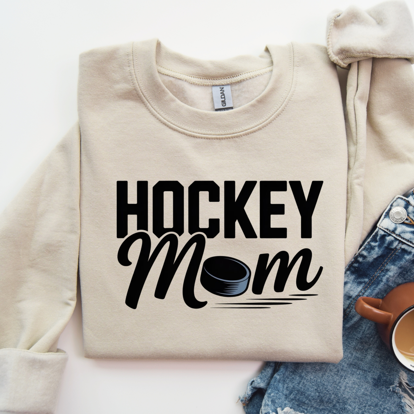 Hockey Mom crewneck sweatshirt with bold hockey-inspired text on a cozy unisex sweatshirt. hockey mom crewneck, hockey mom sweatshirt, hockey parent apparel, sports mom sweatshirt, cozy hockey shirt, hockey family clothing, game day sweatshirt, proud hockey mom, rink side style, unisex crewneck, hockey life apparel, mom gift sweatshirt