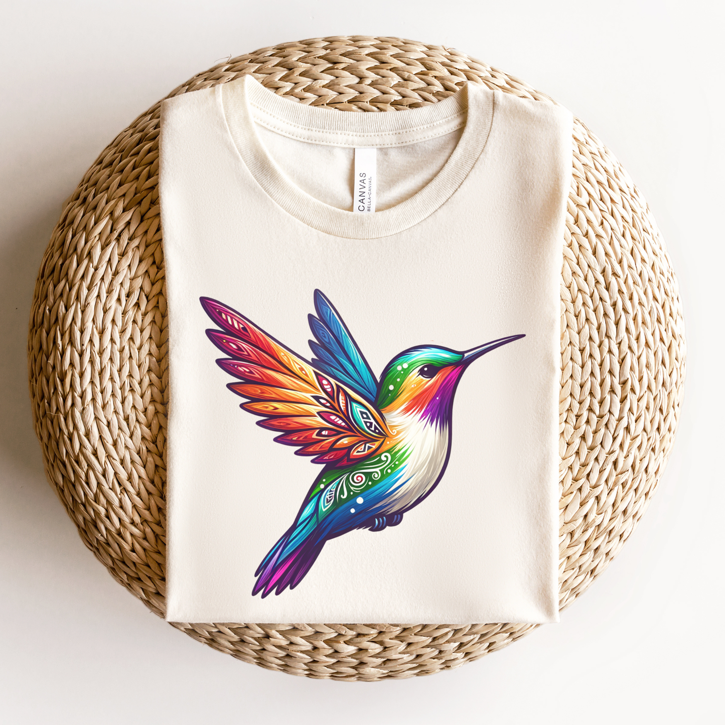 Colourful Indigenous Pride hummingbird design on cream t-shirt featuring rainbow feathers and Indigenous-inspired artwork. Indigenous Pride Shirt, Indigenous Hummingbird Shirt, LGBTQ2S+ Indigenous Apparel, Pride Hummingbird Tee, Indigenous Clothing Canada, Rainbow Hummingbird Shirt, Indigenous Designed Apparel, Native Pride Shirt, Indigenous LGBTQ Shirt