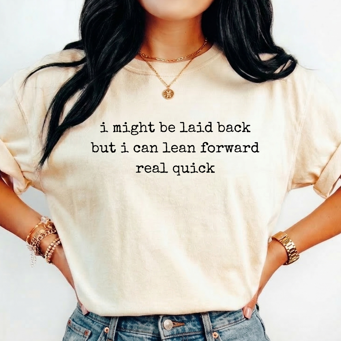 Person wearing a white t-shirt with a humorous text quote, I might be laid back but I can lean forward real quick shirt, sassy attitude t-shirt, funny motivational tee, unisex humor graphic shirt, quick reaction t-shirt, chill vibe attitude tee, bold typography casual shirt, gym motivation shirt, sarcastic everyday tee, indigenous owned funny shirt, laid back strength apparel, real quick response graphic