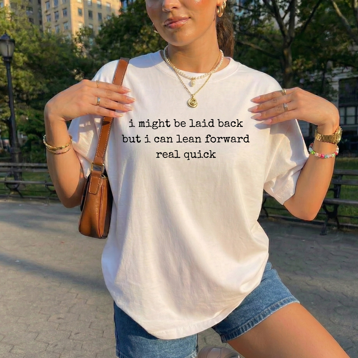 white t-shirt with a humorous text quote, I might be laid back but I can lean forward real quick shirt, sassy attitude t-shirt, funny motivational tee, unisex humor graphic shirt, quick reaction t-shirt, chill vibe attitude tee, bold typography casual shirt, gym motivation shirt, sarcastic everyday tee, indigenous owned funny shirt, laid back strength apparel, real quick response graphic