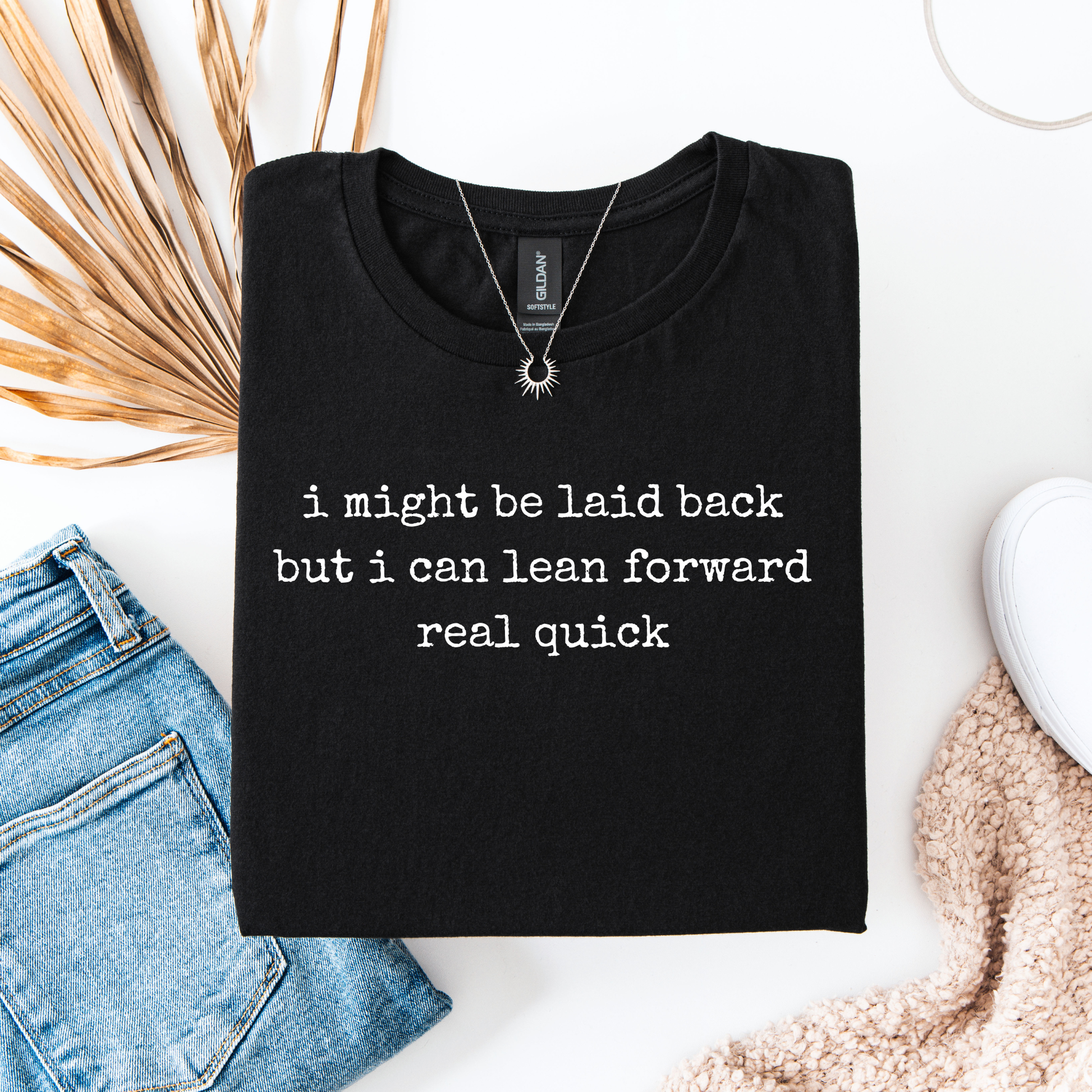 black t-shirt with a humorous text quote, I might be laid back but I can lean forward real quick shirt, sassy attitude t-shirt, funny motivational tee, unisex humor graphic shirt, quick reaction t-shirt, chill vibe attitude tee, bold typography casual shirt, gym motivation shirt, sarcastic everyday tee, indigenous owned funny shirt, laid back strength apparel, real quick response graphic