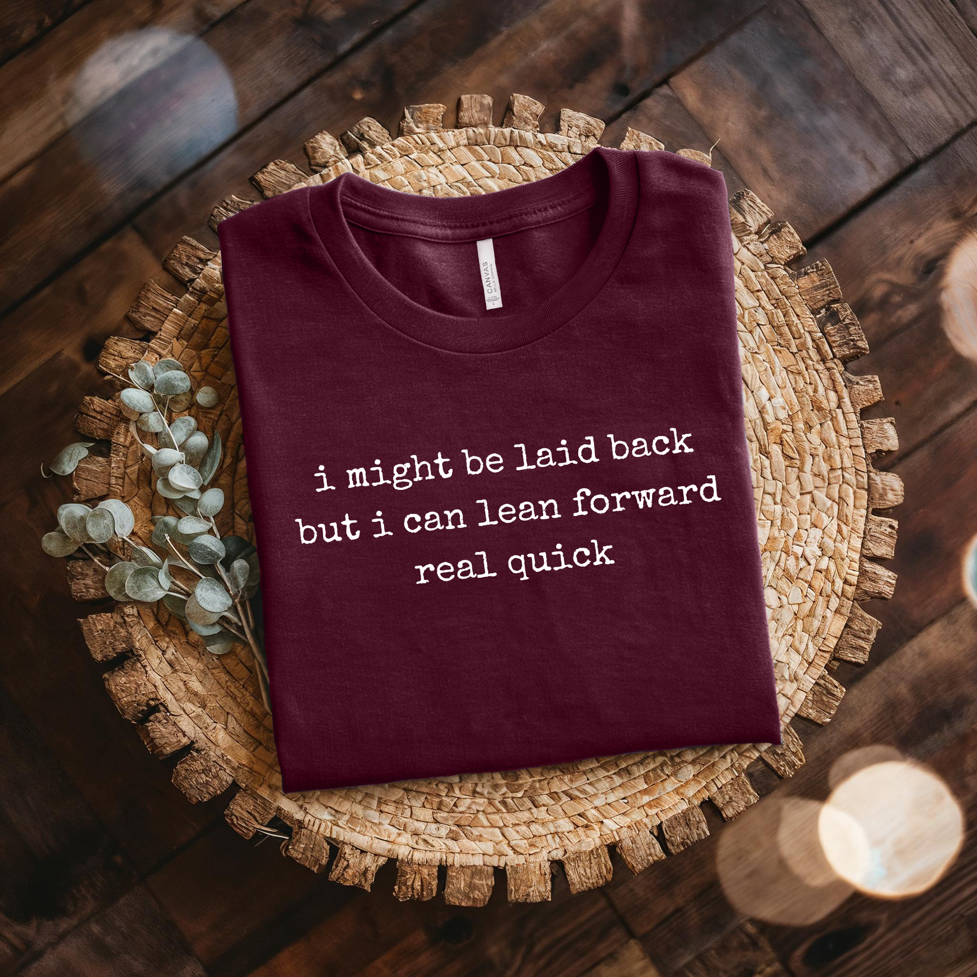 maroon t-shirt with a humorous text quote, I might be laid back but I can lean forward real quick shirt, sassy attitude t-shirt, funny motivational tee, unisex humor graphic shirt, quick reaction t-shirt, chill vibe attitude tee, bold typography casual shirt, gym motivation shirt, sarcastic everyday tee, indigenous owned funny shirt, laid back strength apparel, real quick response graphic