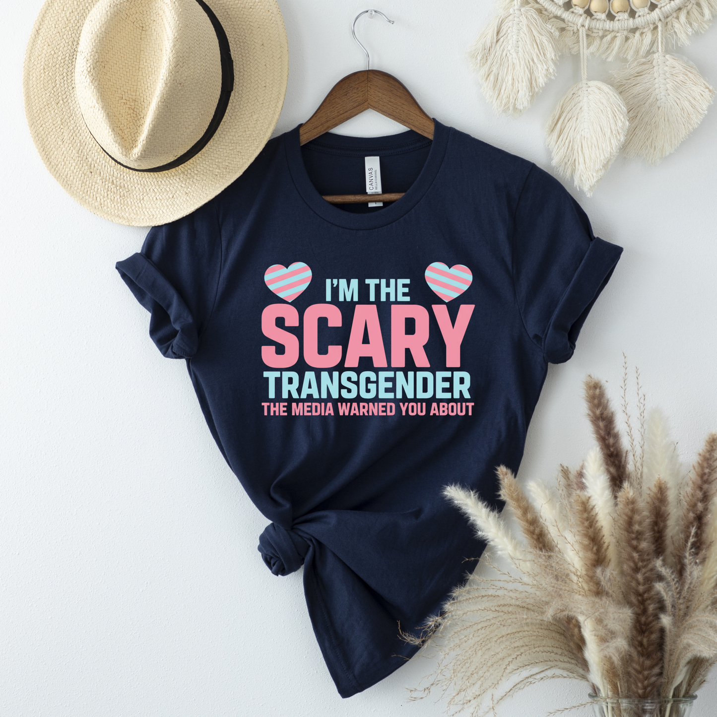 Navy blue t-shirt with 'I'm the Scary Transgender the media warned you about' text on a white background. transgender pride shirt, transgender t-shirt, LGBTQ+ clothing, trans visibility apparel, equality shirt, pride shirt for adults, trans rights clothing, LGBTQ pride tee, gender identity shirt, inclusive fashion, queer clothing brand, pride month outfit, unisex pride shirt, trans empowerment shirt, activism apparel