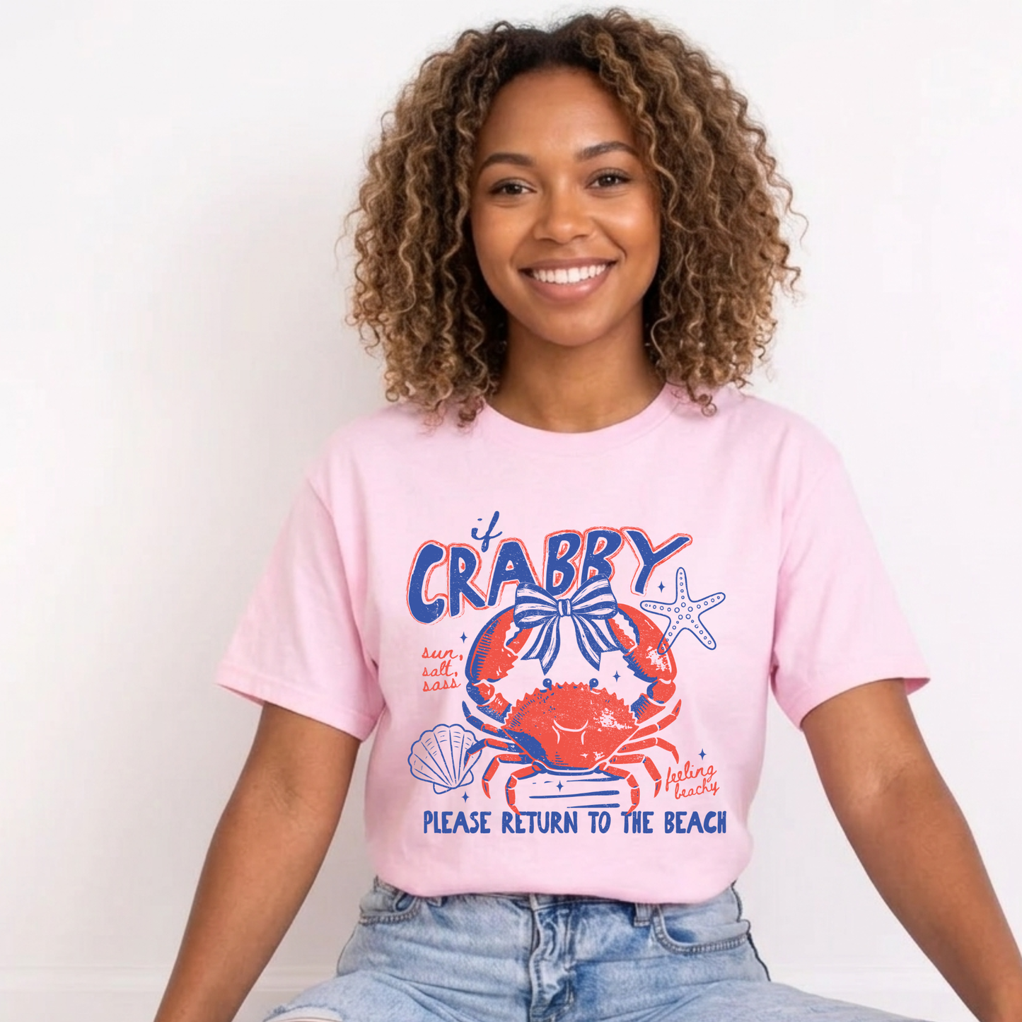 Person wearing a pink t-shirt with a crab graphic and text. beach shirt, coastal tee, funny beach shirt, beach vacation outfit, summer shirt, ocean lover gift, seaside apparel, crab shirt, vacation t-shirt, casual beachwear, coastal clothing, lake life shirt, beach humor tee, seaside gifts, unisex beach shirt