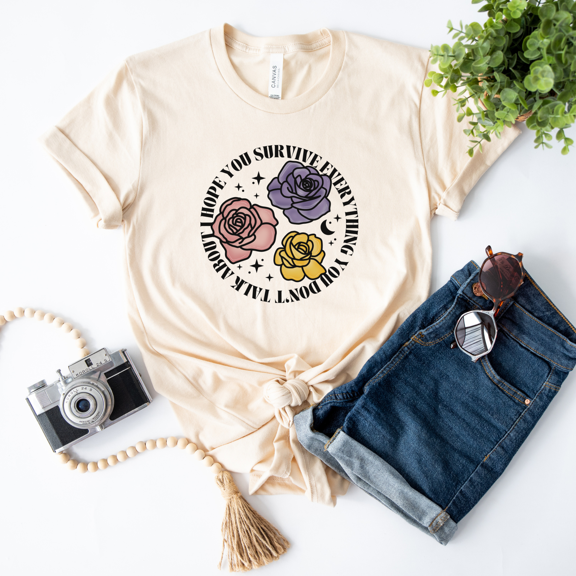 Inspirational floral shirt design featuring three roses in pink, lavender, and yellow with the phrase "I Hope You Survive Everything You Don't Talk About." Mental Health Awareness, Inspirational Shirt, Floral Shirt, Rose Shirt, Encouragement Gift, Self Care Apparel, Positive Message Tee, Inspirational Tee, Floral Graphic Shirt, Unisex T-Shirt, Wellness Apparel, Support Gift, Meaningful Clothing, Floral Fashion, Motivational Shirt, Kindness Matters, Mental Health Support, Graphic Tee, Gift For Her, Gift For 