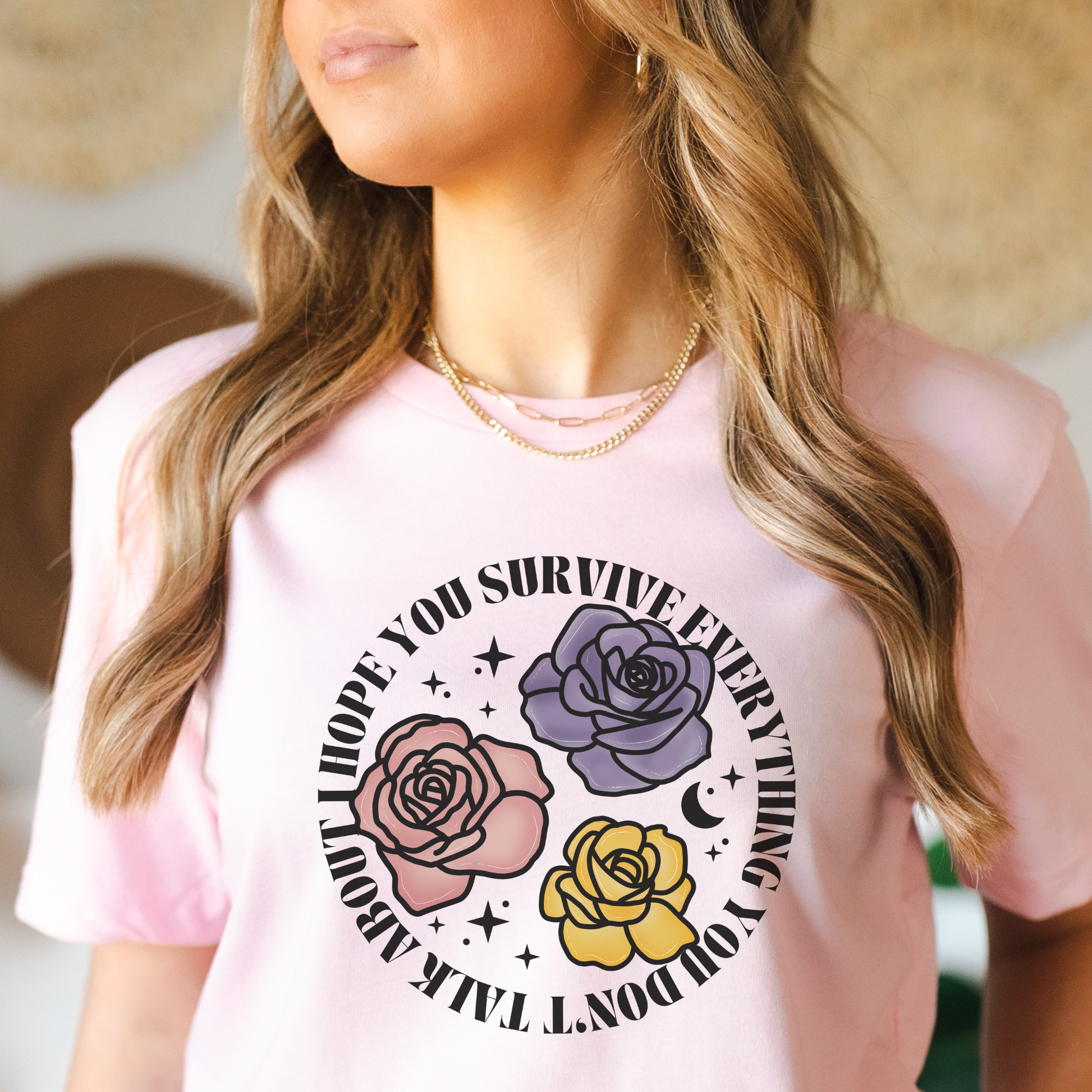 Inspirational floral shirt design featuring three roses in pink, lavender, and yellow with the phrase "I Hope You Survive Everything You Don't Talk About." Mental Health Awareness, Inspirational Shirt, Floral Shirt, Rose Shirt, Encouragement Gift, Self Care Apparel, Positive Message Tee, Inspirational Tee, Floral Graphic Shirt, Unisex T-Shirt, Wellness Apparel, Support Gift, Meaningful Clothing, Floral Fashion, Motivational Shirt, Kindness Matters, Mental Health Support, Graphic Tee, Gift For Her, Gift For 