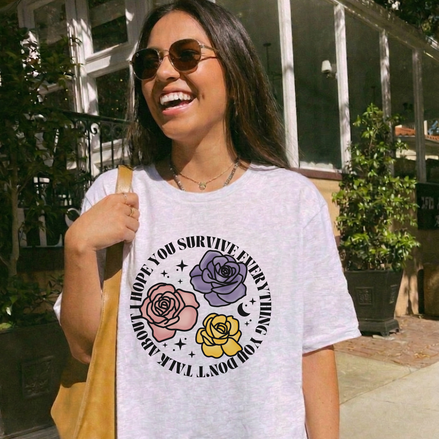 Inspirational floral shirt design featuring three roses in pink, lavender, and yellow with the phrase "I Hope You Survive Everything You Don't Talk About." Mental Health Awareness, Inspirational Shirt, Floral Shirt, Rose Shirt, Encouragement Gift, Self Care Apparel, Positive Message Tee, Inspirational Tee, Floral Graphic Shirt, Unisex T-Shirt, Wellness Apparel, Support Gift, Meaningful Clothing, Floral Fashion, Motivational Shirt, Kindness Matters, Mental Health Support, Graphic Tee, Gift For Her, Gift For 