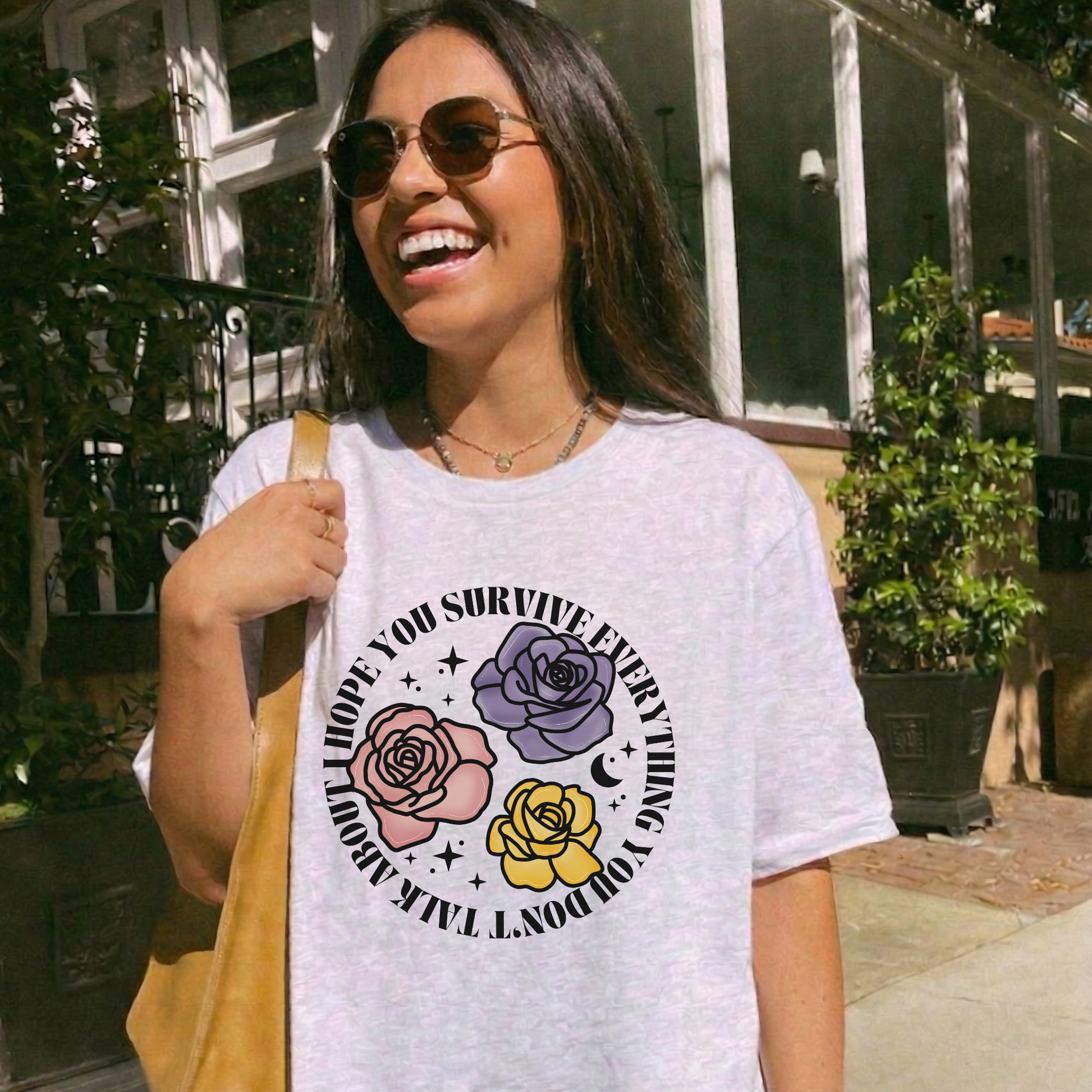 Inspirational floral shirt design featuring three roses in pink, lavender, and yellow with the phrase "I Hope You Survive Everything You Don't Talk About." Mental Health Awareness, Inspirational Shirt, Floral Shirt, Rose Shirt, Encouragement Gift, Self Care Apparel, Positive Message Tee, Inspirational Tee, Floral Graphic Shirt, Unisex T-Shirt, Wellness Apparel, Support Gift, Meaningful Clothing, Floral Fashion, Motivational Shirt, Kindness Matters, Mental Health Support, Graphic Tee, Gift For Her, Gift For 