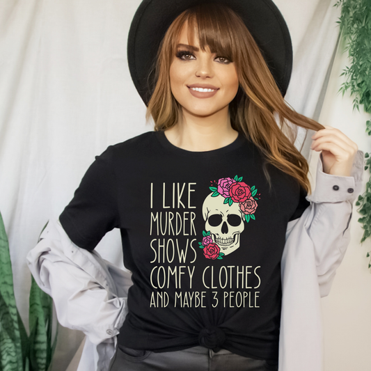 t-shirt featuring a floral skull graphic with the quote "I Like Murder Shows, Comfy Clothes and Maybe 3 People. true crime shirt, murder shows shirt, funny introvert shirt, comfy clothes shirt, true crime lover gift, crime podcast shirt, funny graphic tee, skull floral shirt, homebody shirt, netflix shirt, murder mystery fan, sarcastic shirt, cozy aesthetic shirt
